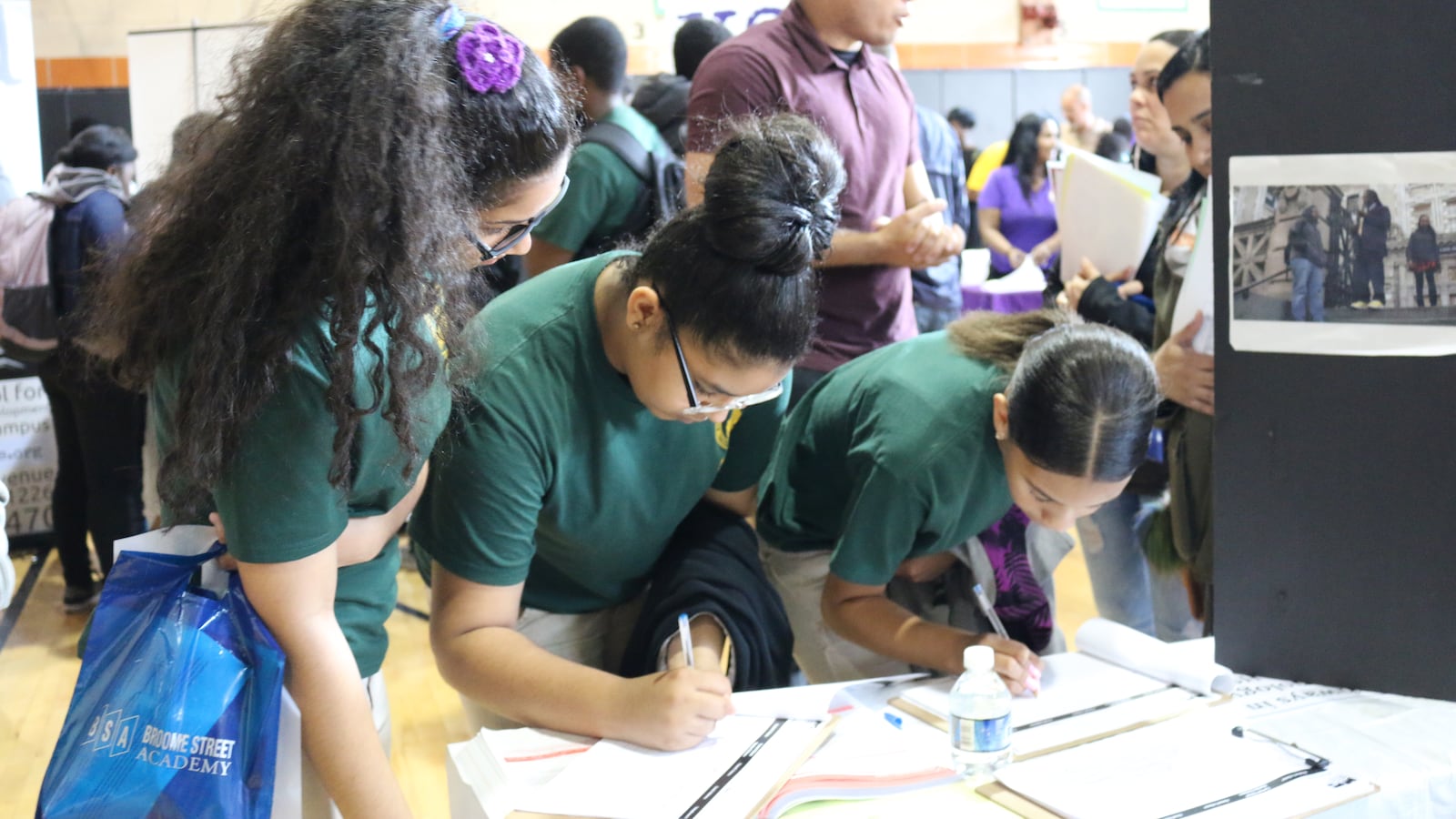 Middle school students write their names down at a high school fair in Brooklyn in 2016.