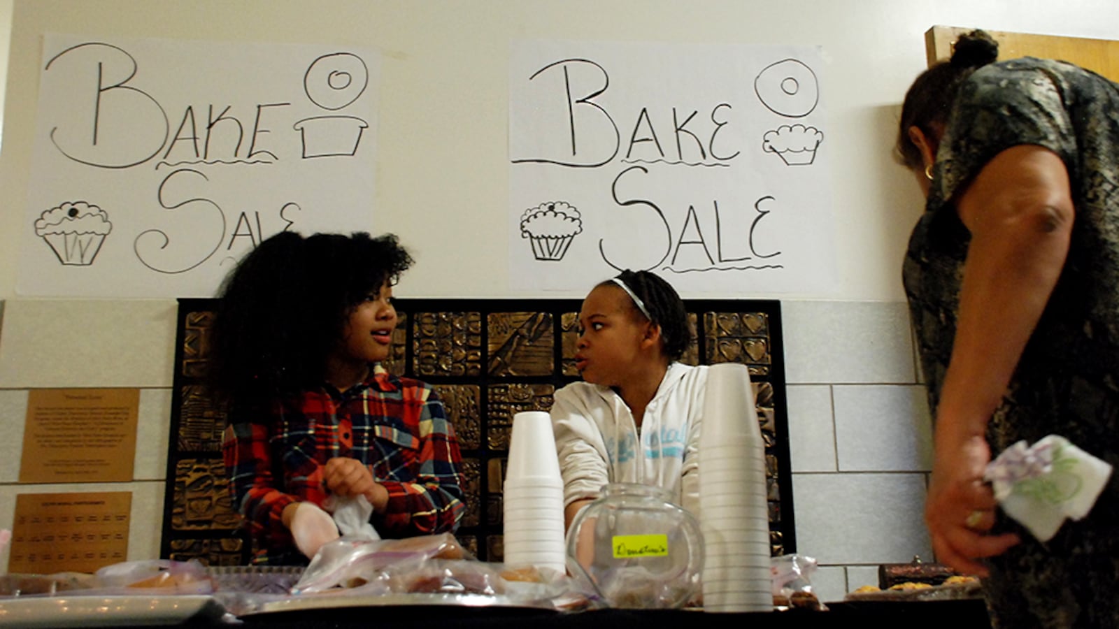 Carmen Stevens, left, and Amarria Miller volunteer at their classroom's bake sale in December 2015. The Gilpin Montessori students were raising funds for their class pets.