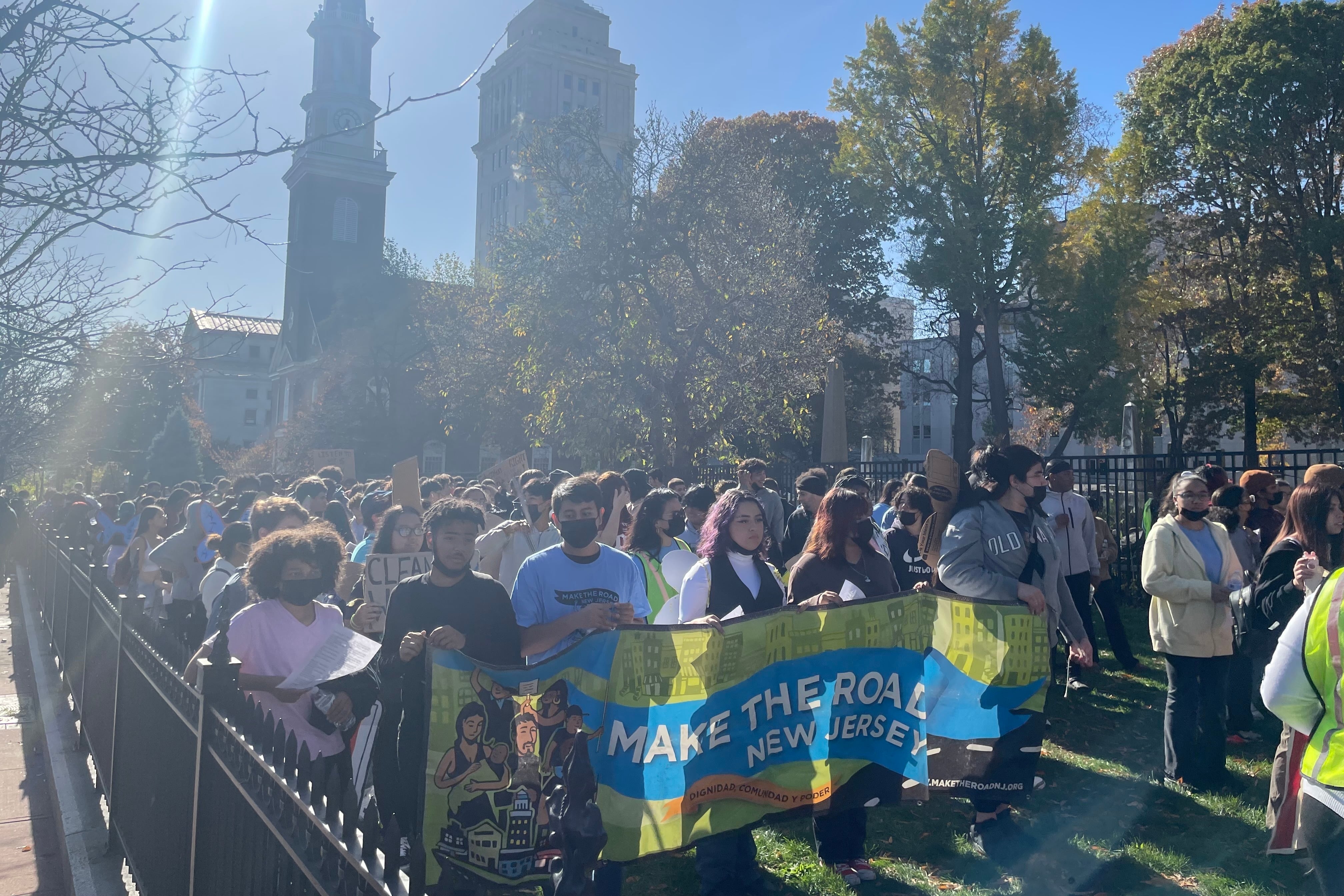 Dozens of teenagers gather on a lawn before marching in a protest.