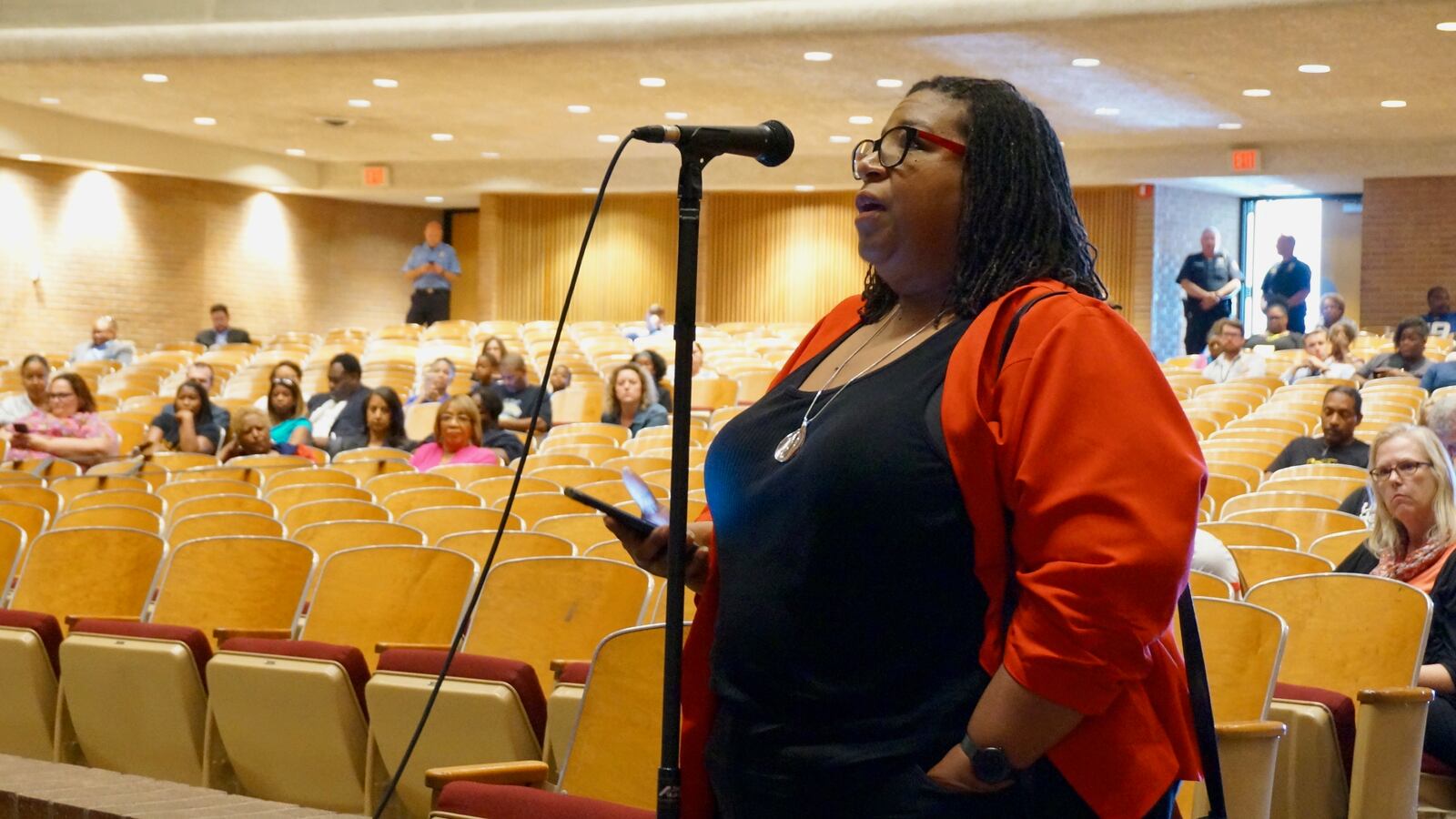 Andrea Price, an alumna of Arlington High School, was one of dozens who spoke at a meeting about converting the campus to a middle school.