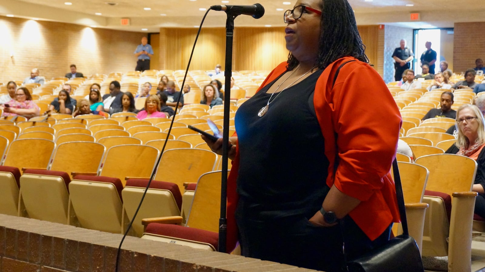 Andrea Price, an alumna of Arlington High School, was one of dozens who spoke at a meeting about converting the campus to a middle school.