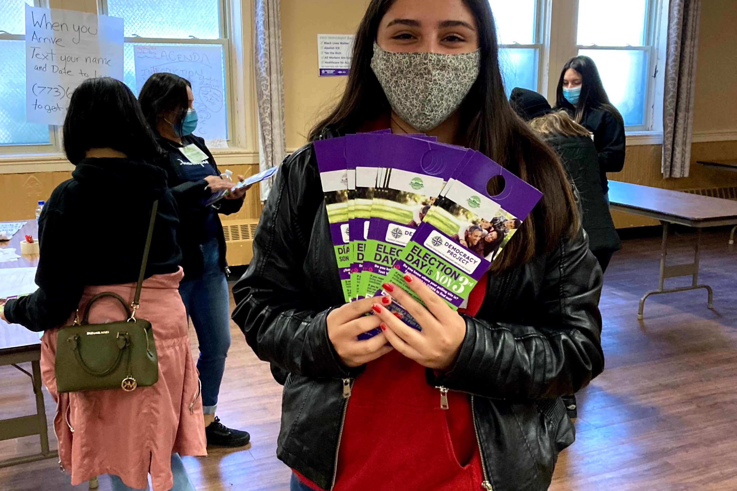 Chicago high school junior Alexa Valenzuela drops off get-out-the-vote literature in Albany Park on Nov. 3, 2020. The community organization Communities United partnered with several Chicago high schools on the effort.