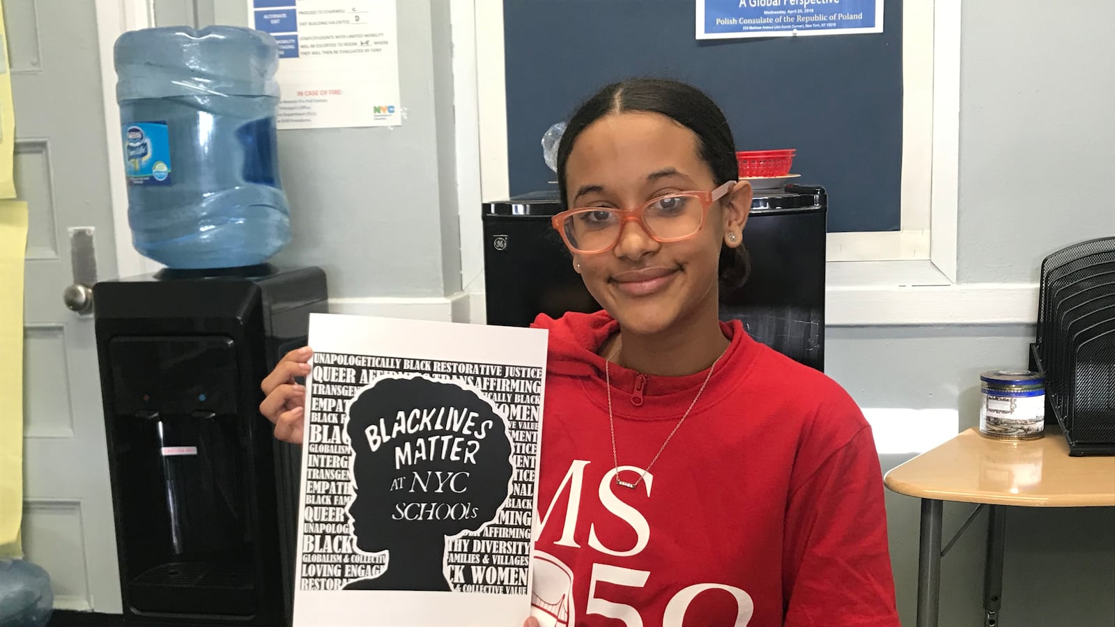 Emma Pichardo, a student at Brooklyn middle school, holds up her winning design for a Black Lives Matter t-shirt contest.