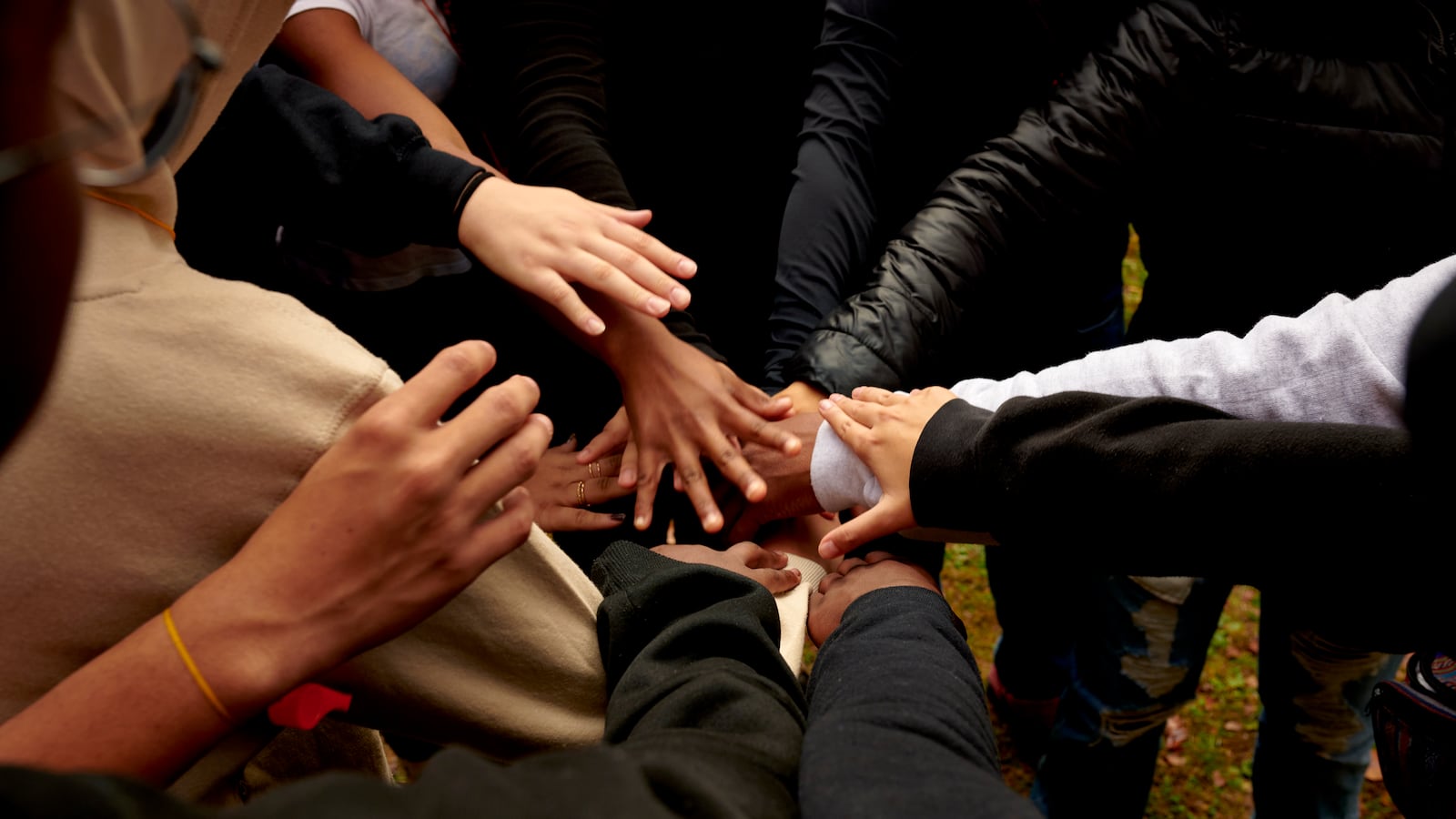 Students put their hands together during an exercise.