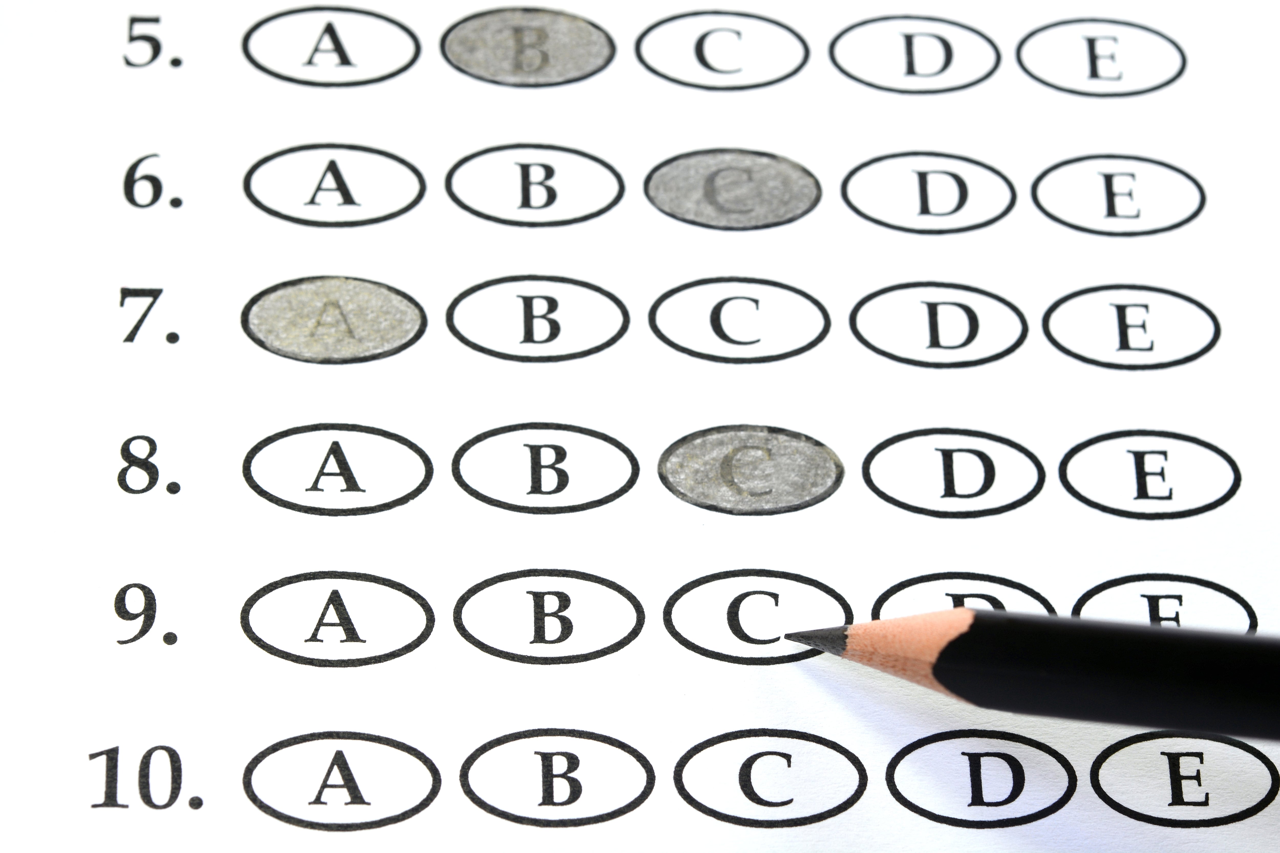 Fill-in bubbles on a test paper with a pencil.