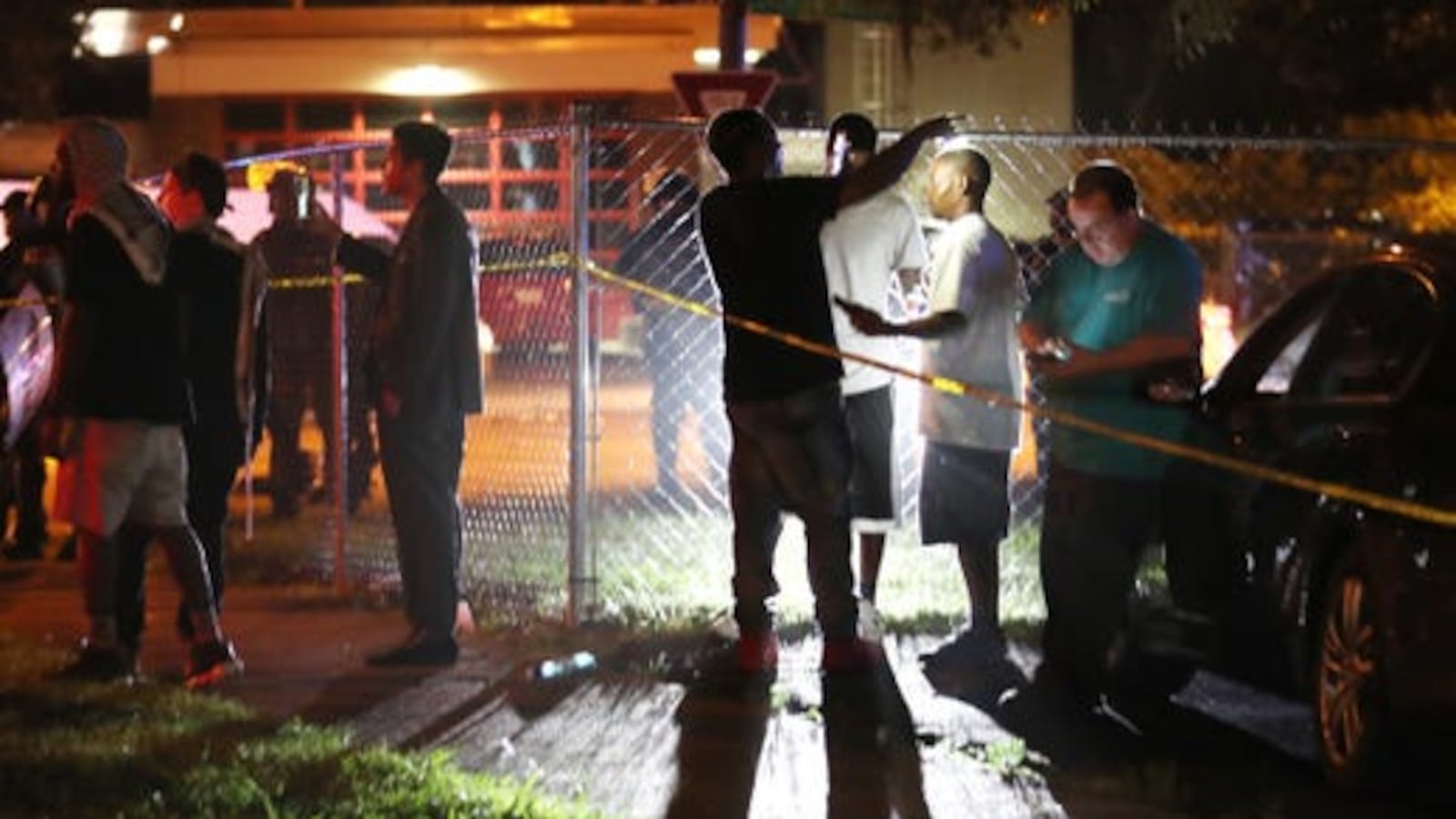 Onlookers talk following an shooting in Frayser involving the U.S. Marshals Service that left Brandon Webber dead on June 12, 2019.