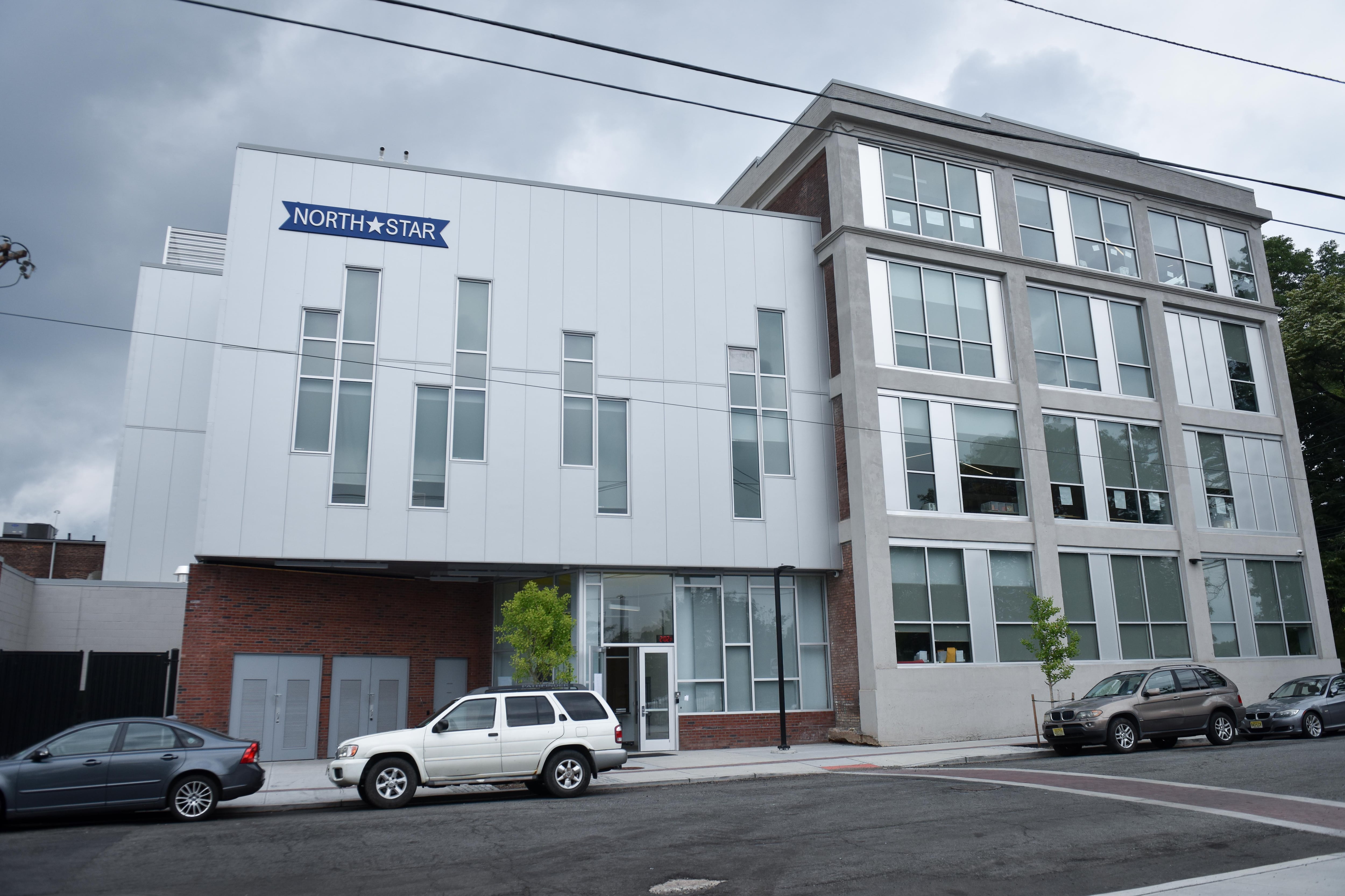 A school building has a blue sign on the top left corner that reads North Star in white lettering with a white star shape between the two words.