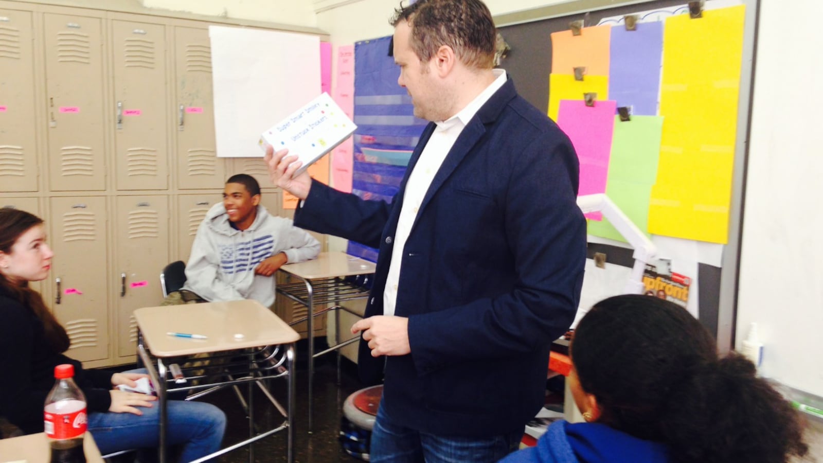 Mark Federman, principal of Manhattan's East Side Community School, passed out "Super Smart Smiley Unstuck Stickers" before the English exams Tuesday.