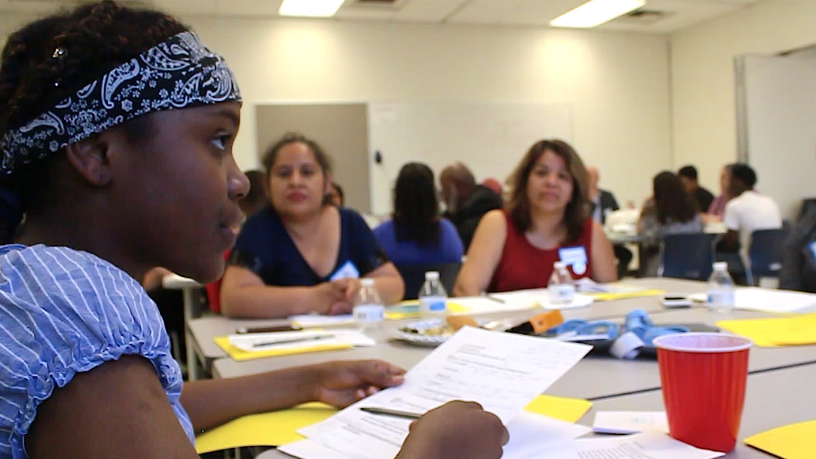A table of students, parents, educators and community members participate in a conversation hosted by Chalkbeat Chicago and Generation All.
