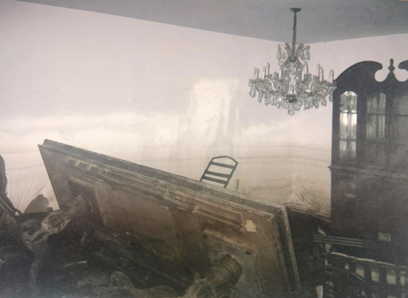 A photograph of a dining room destroyed after a hurricane.