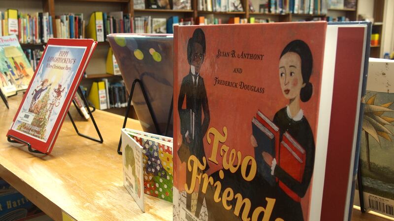 The book “Two Friends” on a display stand on a shelf in an elementary school library