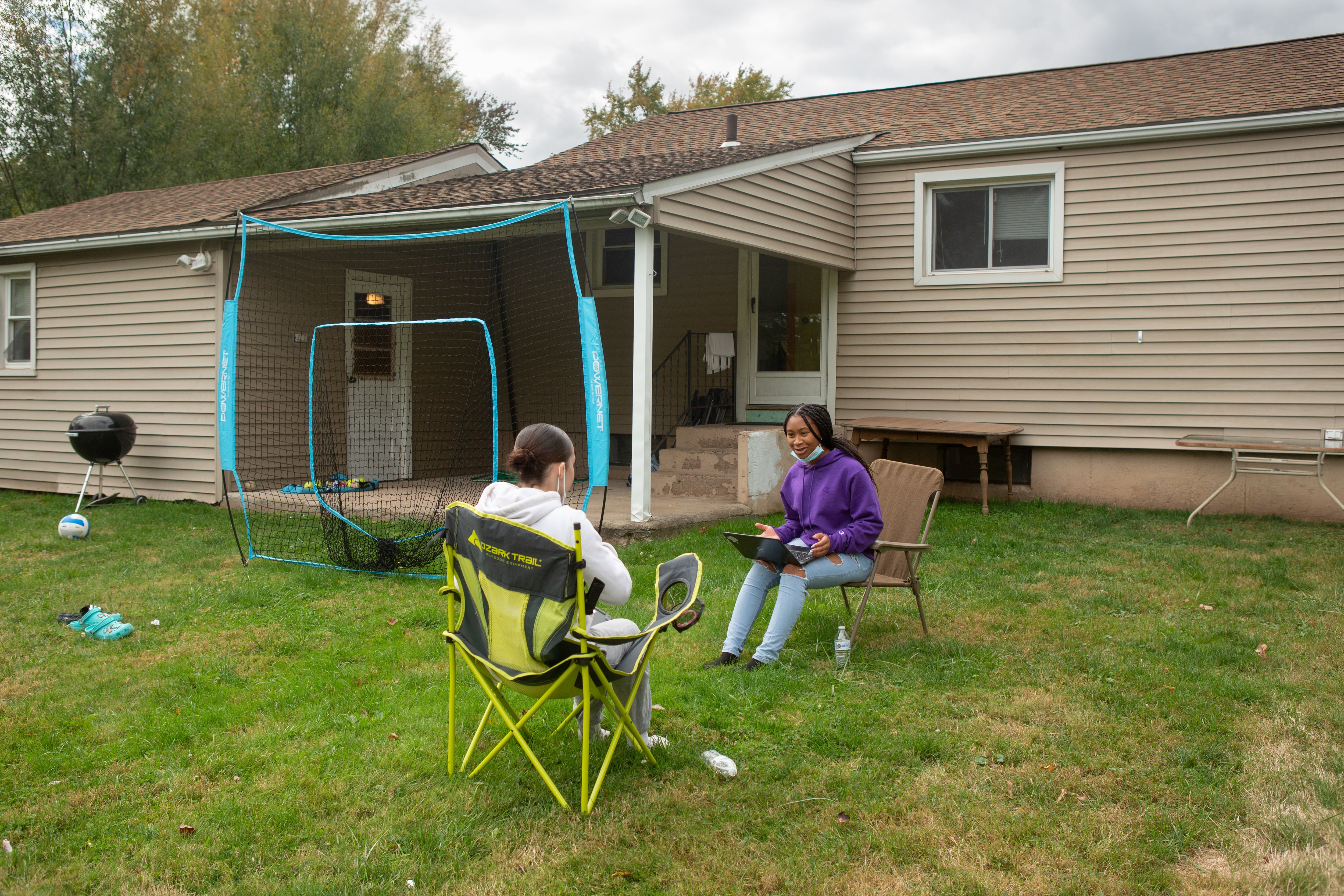 Middletown High School students Pilar Brooks and Devyn Wagner-Morella study together outside Brooks’ home.