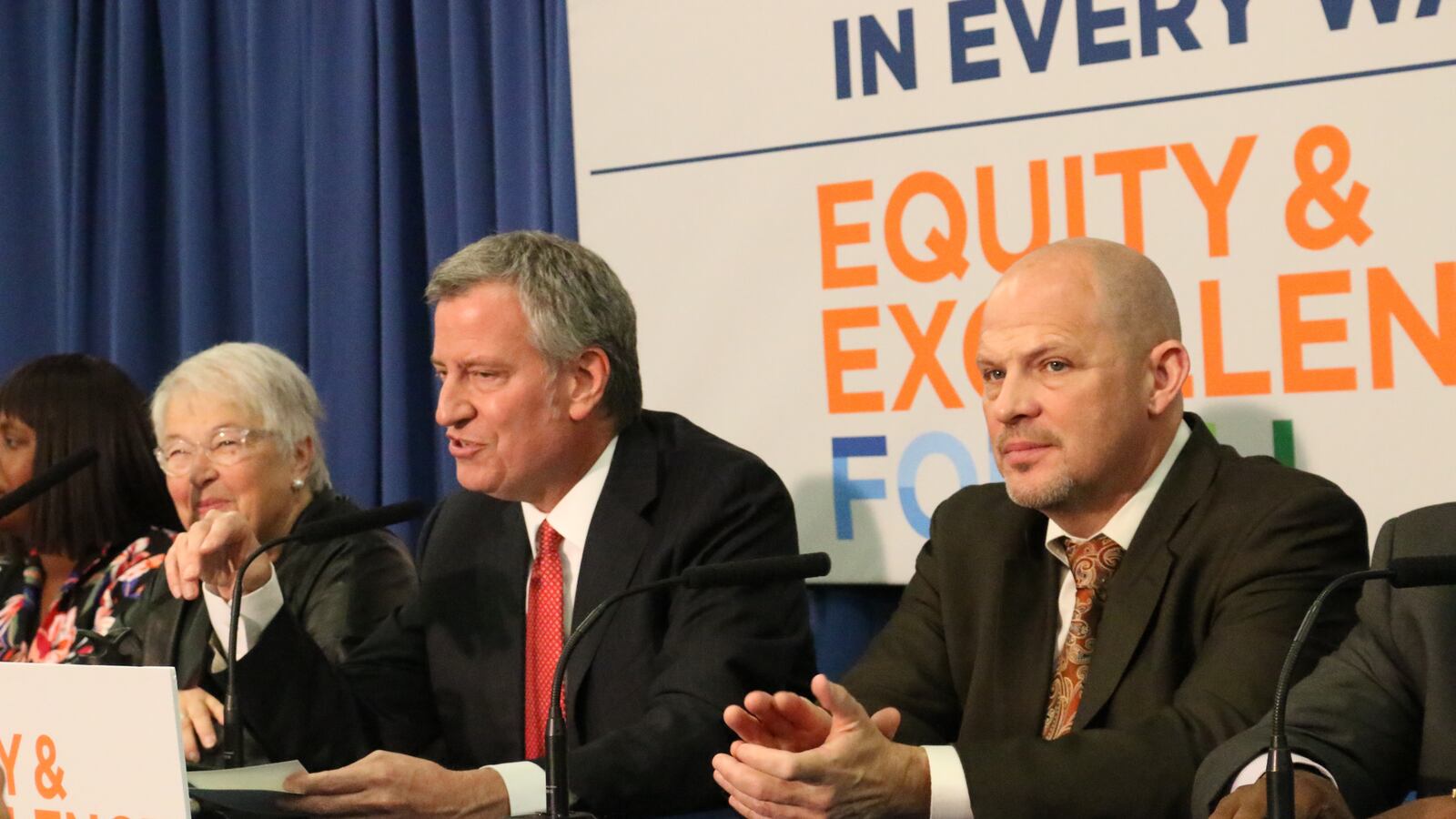 United Federation of Teachers President Michael Mulgrew, right, says the union is negotiating with Mayor Bill de Blasio, center, for a paid family leave policy.