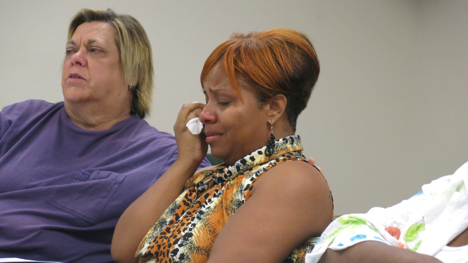 Shelby County Schools teacher Shanda Hunt wipes her tears as she talks about how hard it has been to be unemployed and in search of a teaching job.  She was laid off last year, in May 2014.