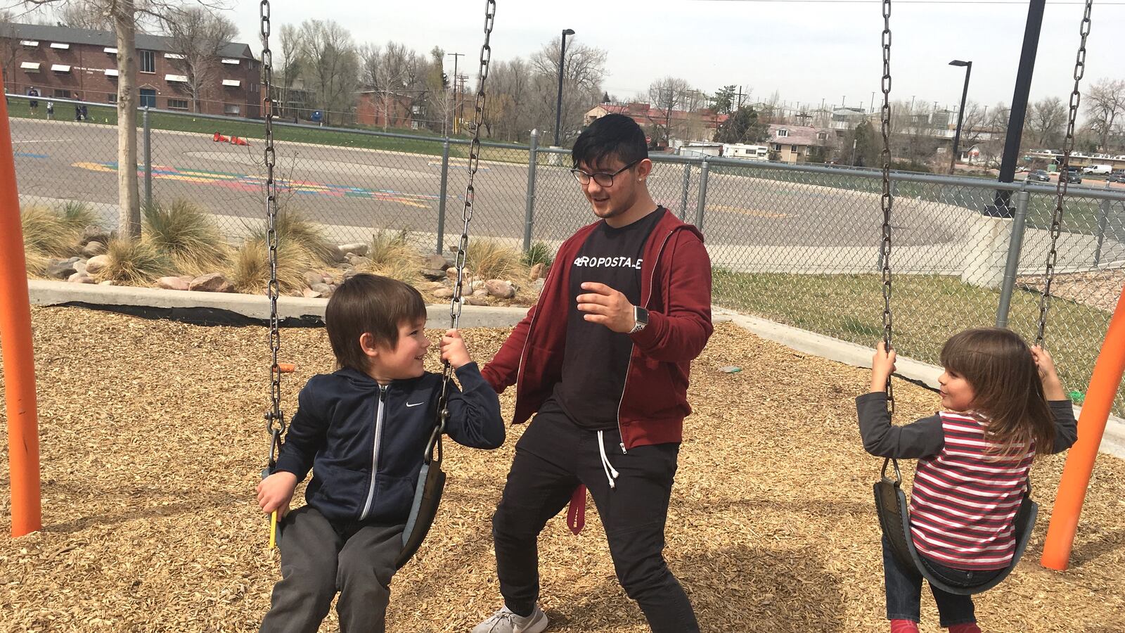 Julian Salazar, 18, plays with preschool children at an internship that's part of his high school's early childhood pathway program.