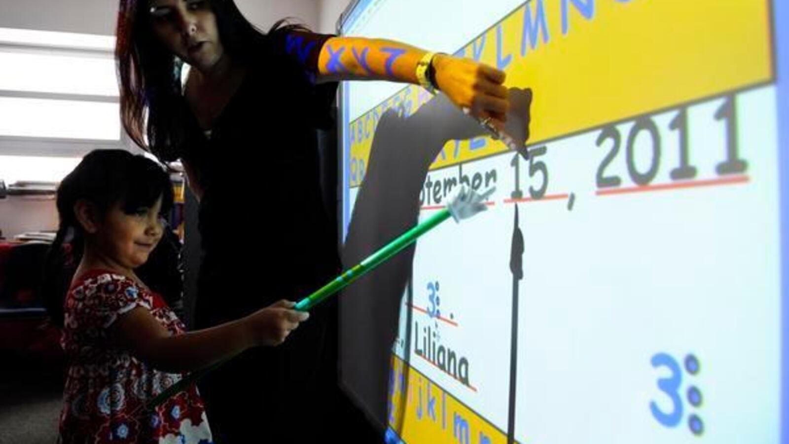 Teacher Jonell Tafoya works with student Liliana Lucero in 2011 at Gust Elementary in southwest Denver.