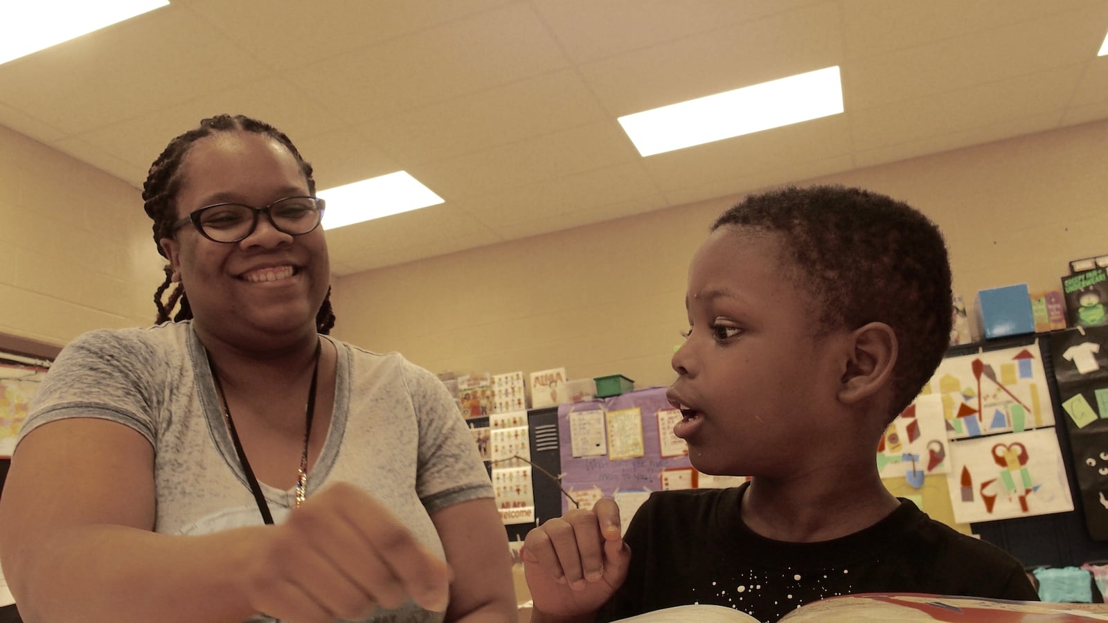 Teacher Dorian Lloyd helps rising first-grader Nykari McNeal sound out words during a state-funded reading camp at Cornerstone Prep Denver, a Memphis charter school in the Achievement School District.