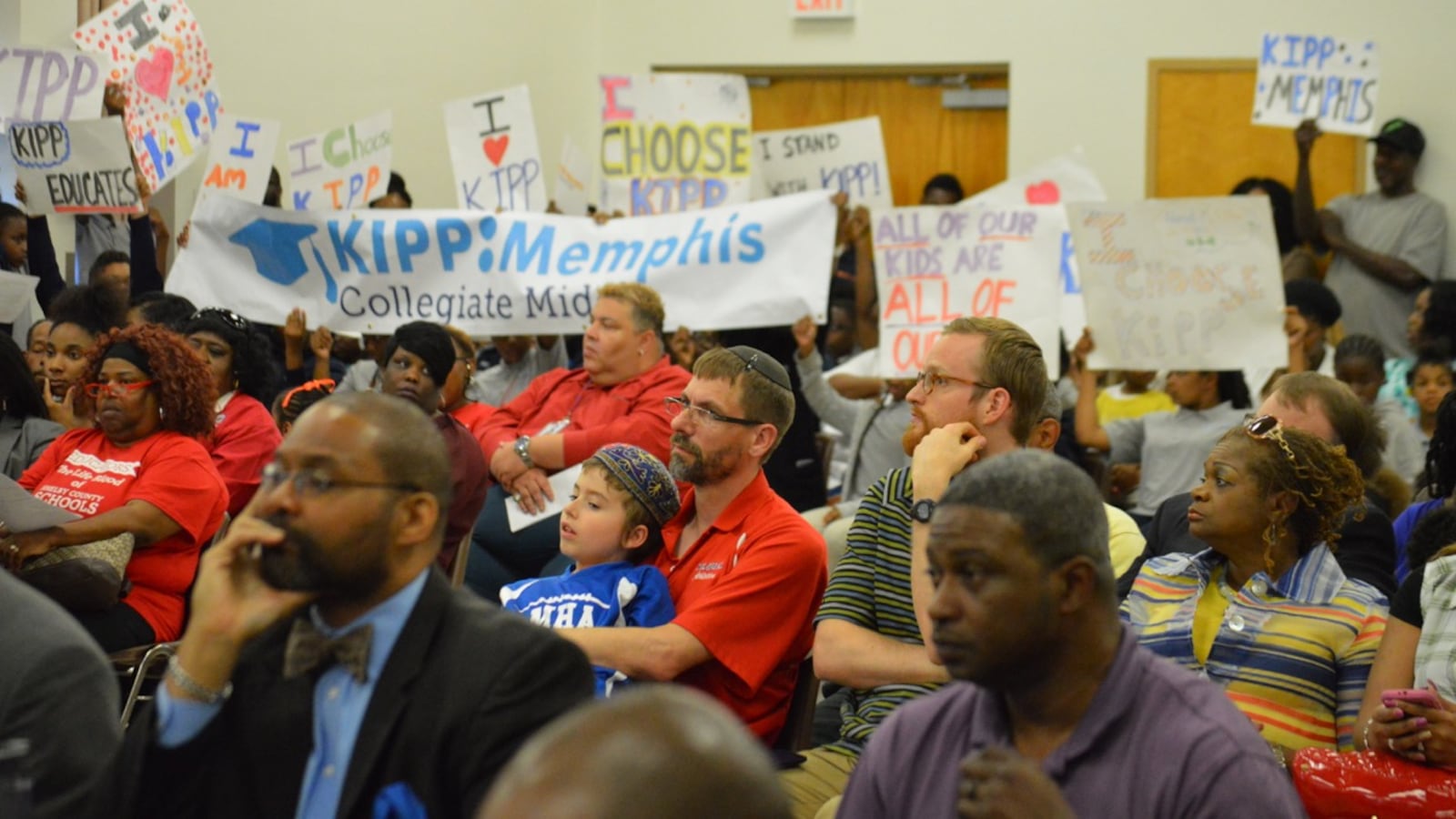 Supporters of KIPP charter schools in Memphis lobby for their schools to remain open during Tuesday evening's Shelby County school board meeting.