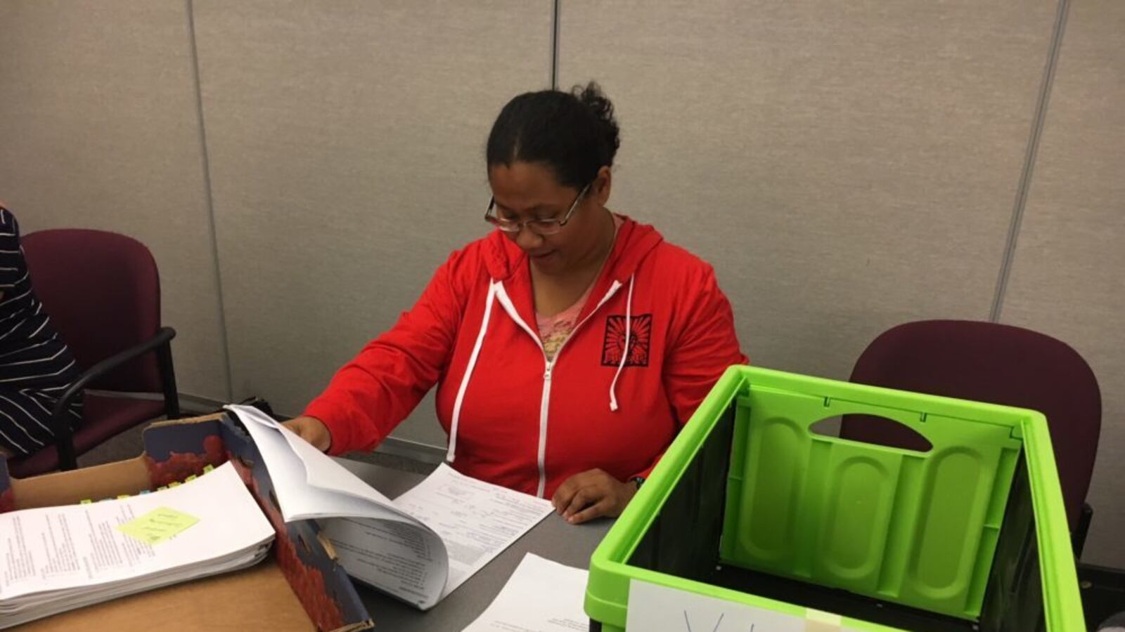 Joi Lin, a Boulder Valley Education Association employee, checks notary pages on petitions for Great Schools, Thriving communities. (Erica Meltzer/Chalkbeat)