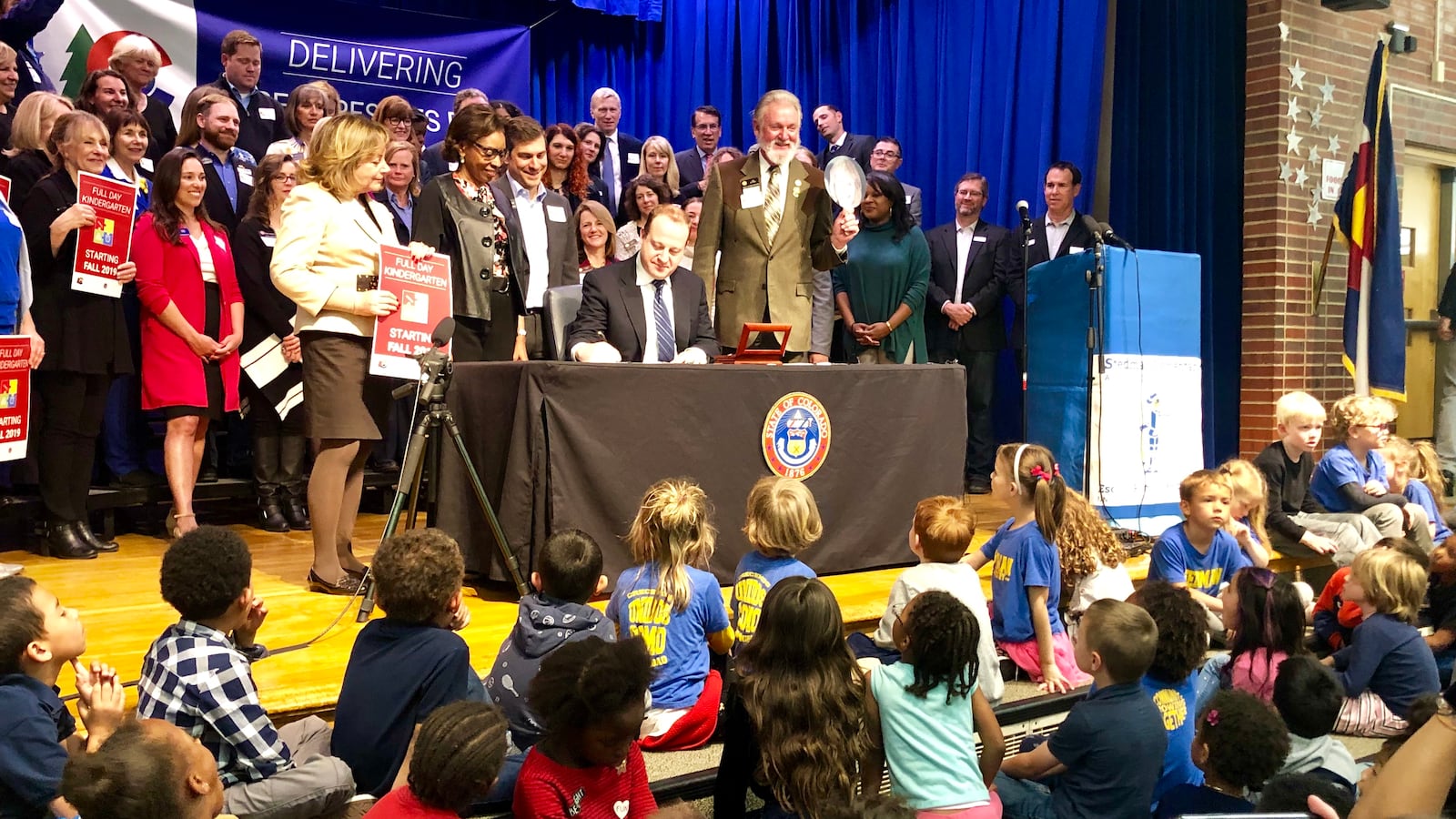 Dozens of Stedman Elementary kindergarteners look on as Gov. Polis signs the full-day kindergarten bill into law.