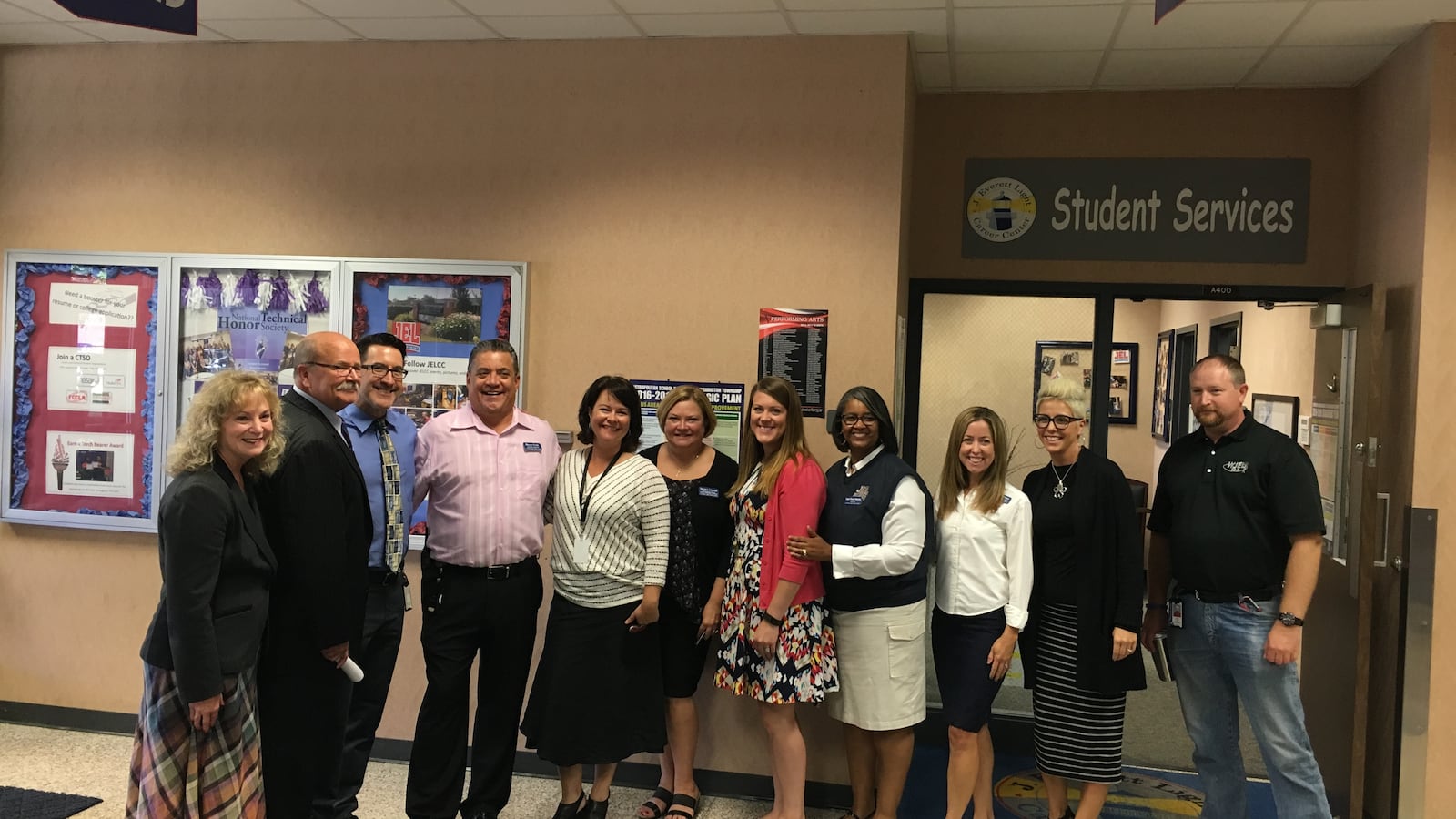 State superintendent Glenda Ritz and Democratic candidate for governor John Gregg pose with staff from Washington Township's J. Everett Light Career Center. After the tour, Chalkbeat asked the candidates about the state's role in reducing school segregation.