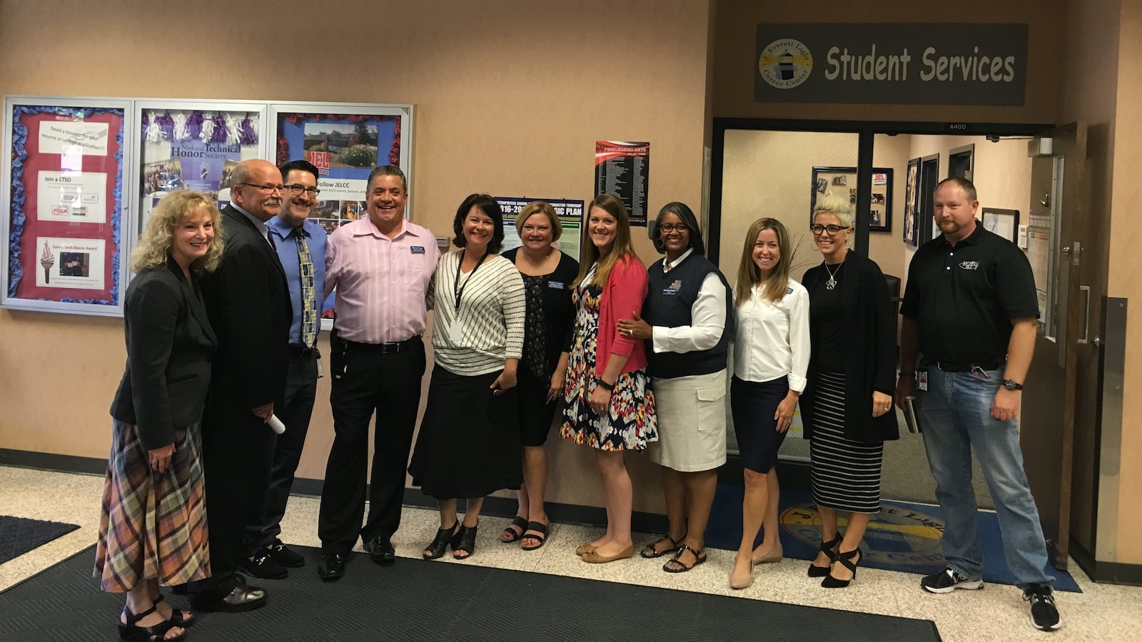 State superintendent Glenda Ritz and Democratic candidate for governor John Gregg pose with staff from Washington Township's J. Everett Light Career Center. After the tour, Chalkbeat asked the candidates about the state's role in reducing school segregation.
