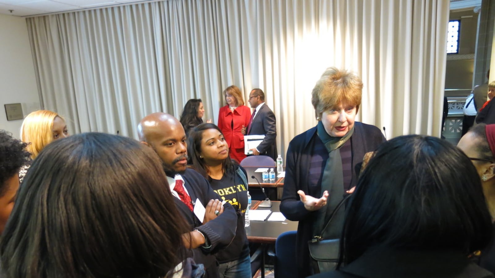 Teaching Firms of America co-founder Rafiq Kalam Id-Din, with parents and staff of the school, speak with Regents Kathleen Cashin in Albany after a meeting about charter school authorization in 2014. In a rare move, Regents said they would not approve a spate of charter school renewal recommendations submitted to them by the city's Department of Education because they lacked consistency.