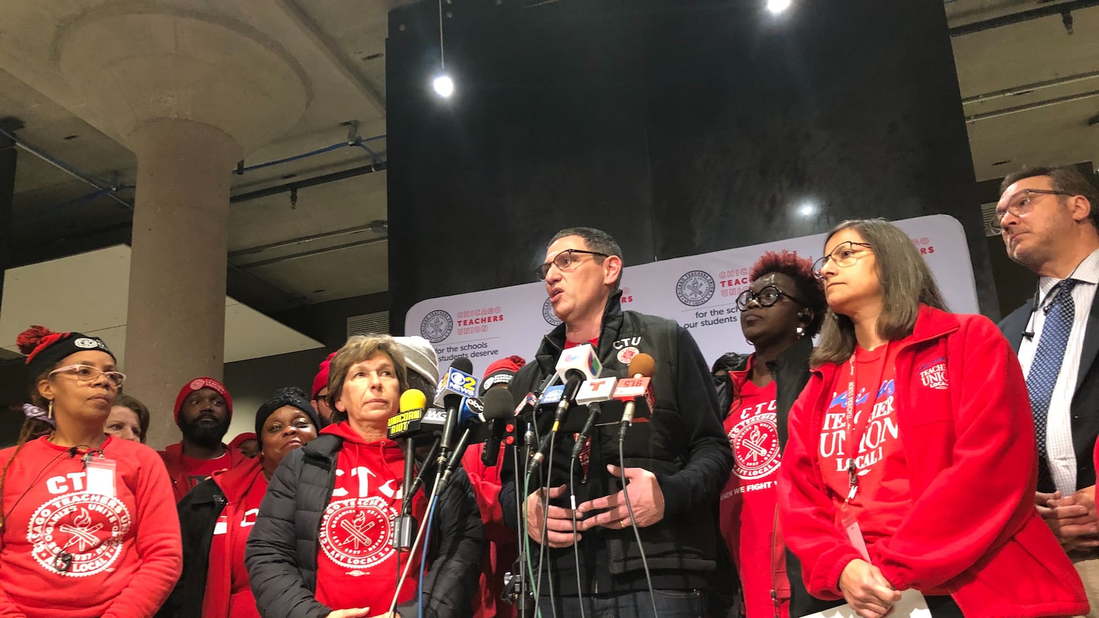 Chicago Teachers Union chief Jesse Sharkey, stands with union leaders after a House of Delegates vote to accept a tentative contract, Oct. 30, 2019.