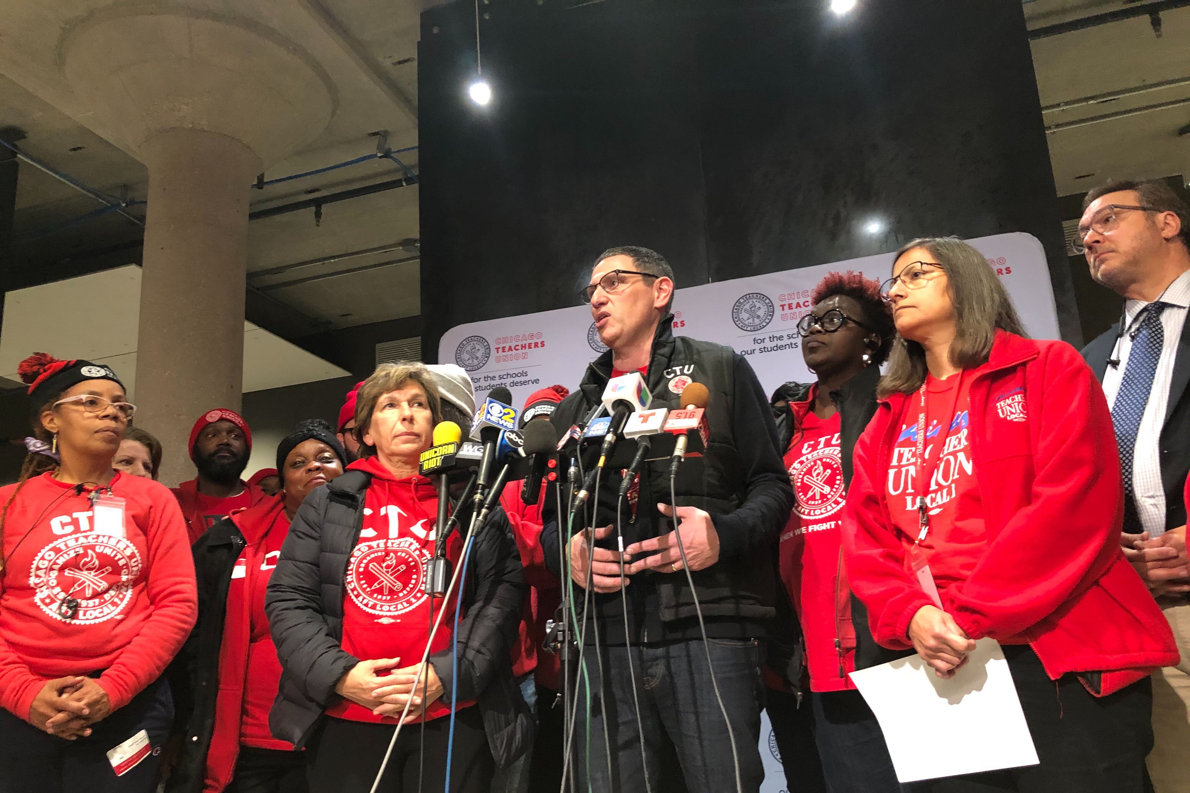Chicago Teachers Union chief Jesse Sharkey, stands with union leaders after a House of Delegates vote to accept a tentative contract, Oct. 30, 2019.