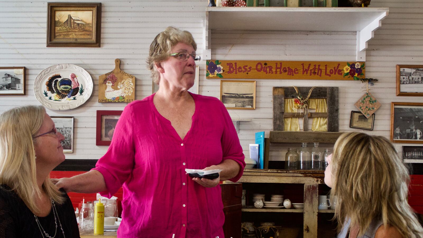 Retired English teacher Peggy Allen, center, speaks with Otis Principal Michelle Patterson, left, and Superintendent Kendra Anderson at Mama's, the town's lone restaurant. (Photo by Nic Garcia)