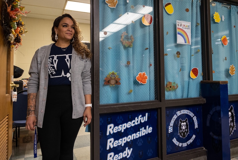 A woman stands in a school office