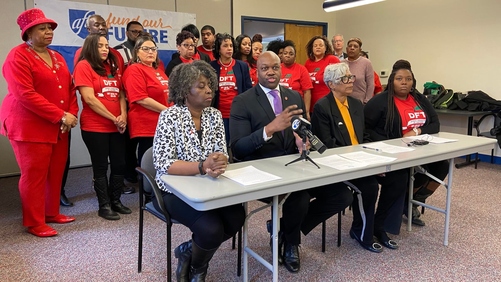 Terrence Martin (second from left), president of the Detroit Federation of Teachers, says the Detroit district is on stable enough footing to increase teacher pay.