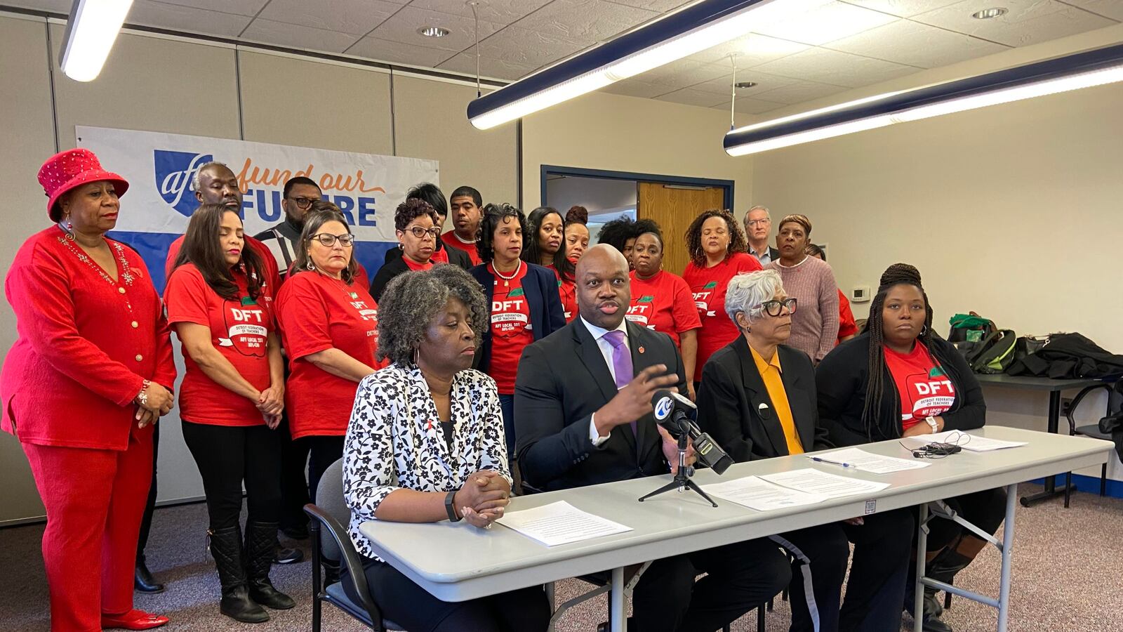 Terrence Martin (second from left), president of the Detroit Federation of Teachers, says the Detroit district is on stable enough footing to increase teacher pay.
