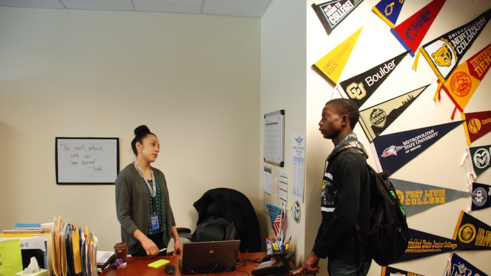 Hinkley College Center director Jazmin Lopez speaks with senior Moise Kombo in January.