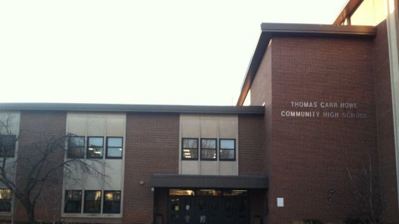 The photo shows a multi-story brick building with the words “Thomas Carr Howe Community High School” on the right.