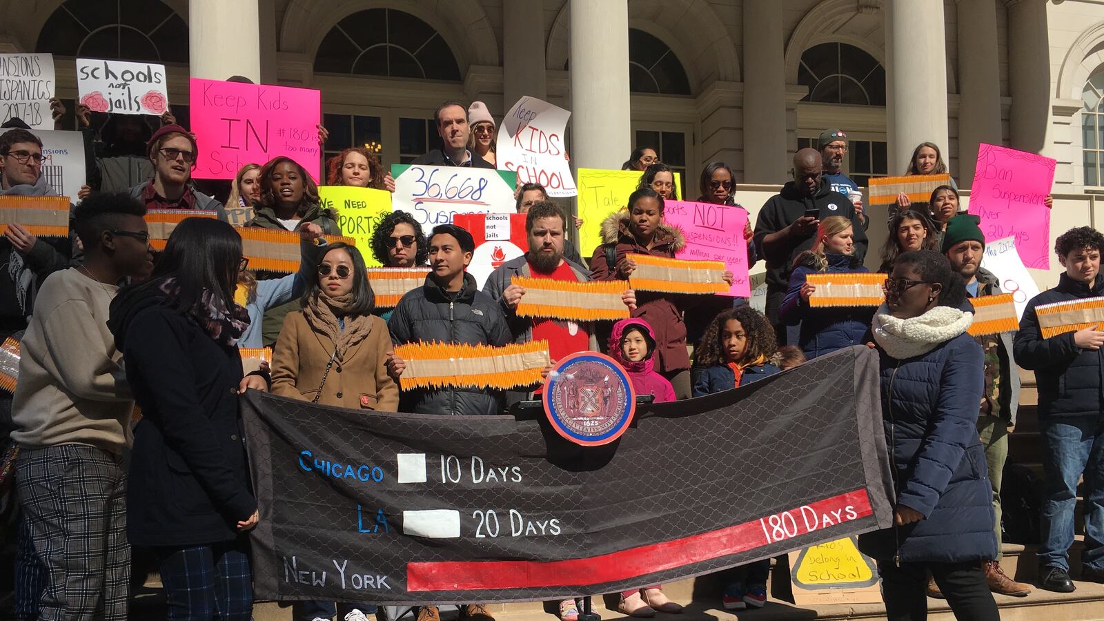 Students protest lengthy suspensions outside City Hall.