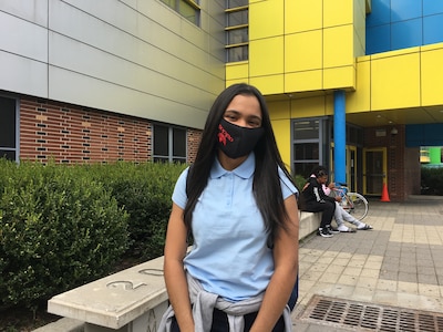 Ashanty Peralta wearing an Adidas face mask standing outside Urban Assembly School for Applied Math and Science.