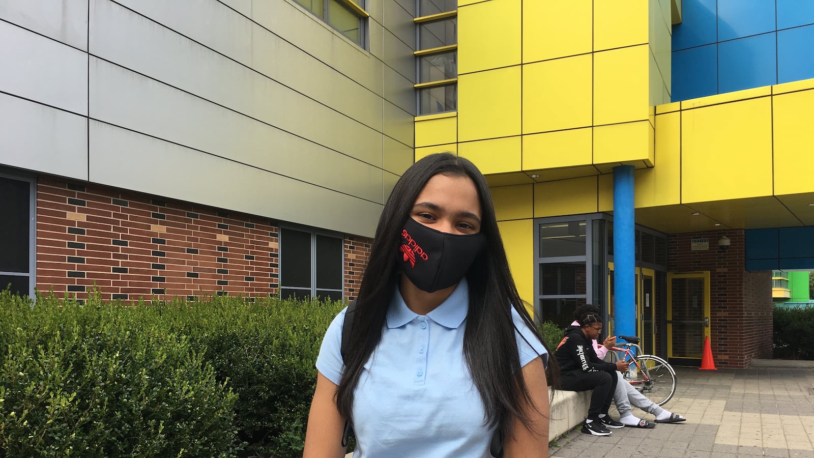 Ashanty Peralta wearing an Adidas face mask standing outside Urban Assembly School for Applied Math and Science.