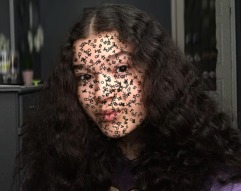 A self portrait of Casandra Sotelo-Rivera with tiny black lettering over her face.