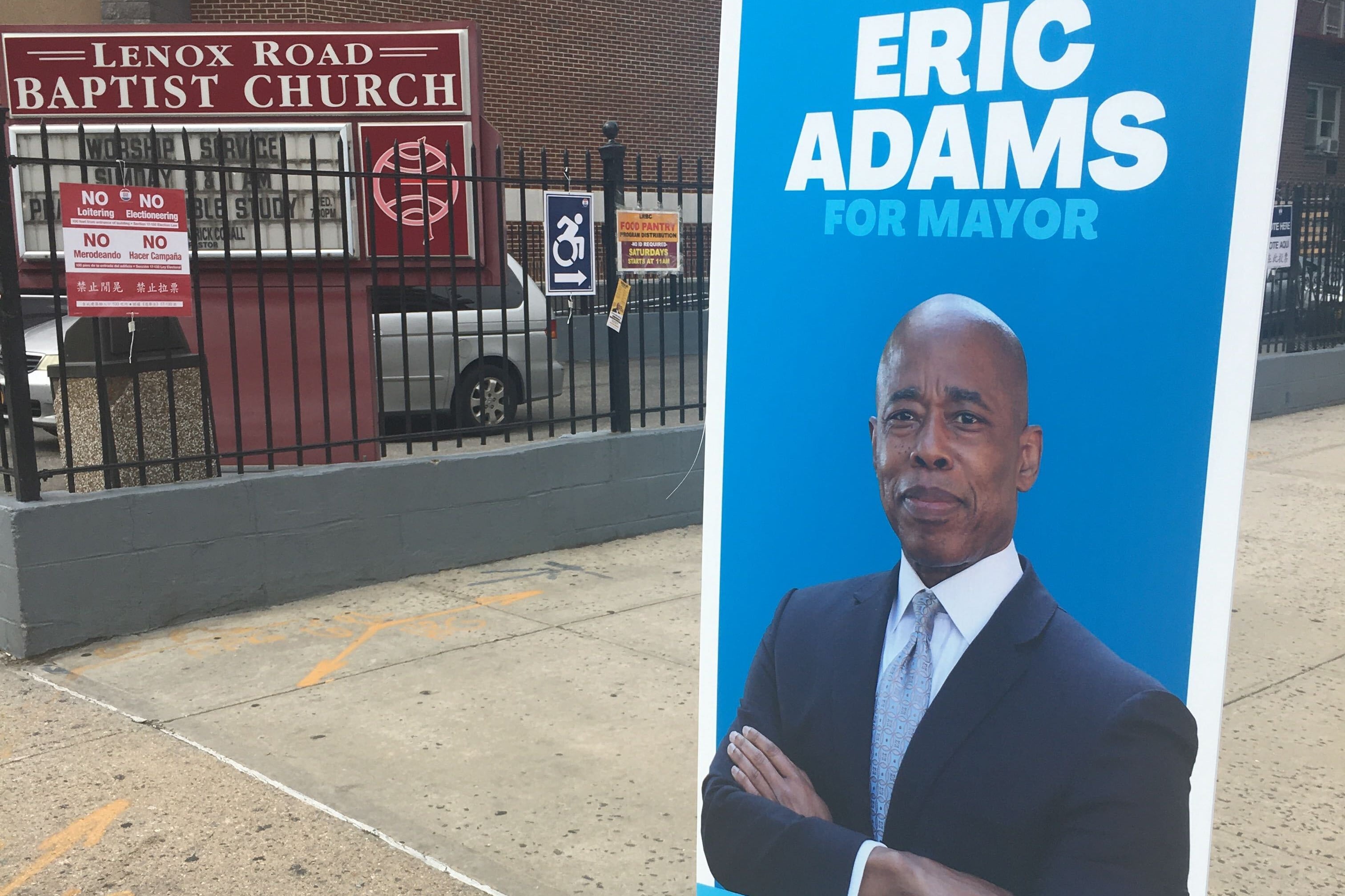 Eric Adams led the crowded field of Democratic mayoral hopefuls as of Tuesday night. A sign for the candidate on the street in front of a Brooklyn polling site.