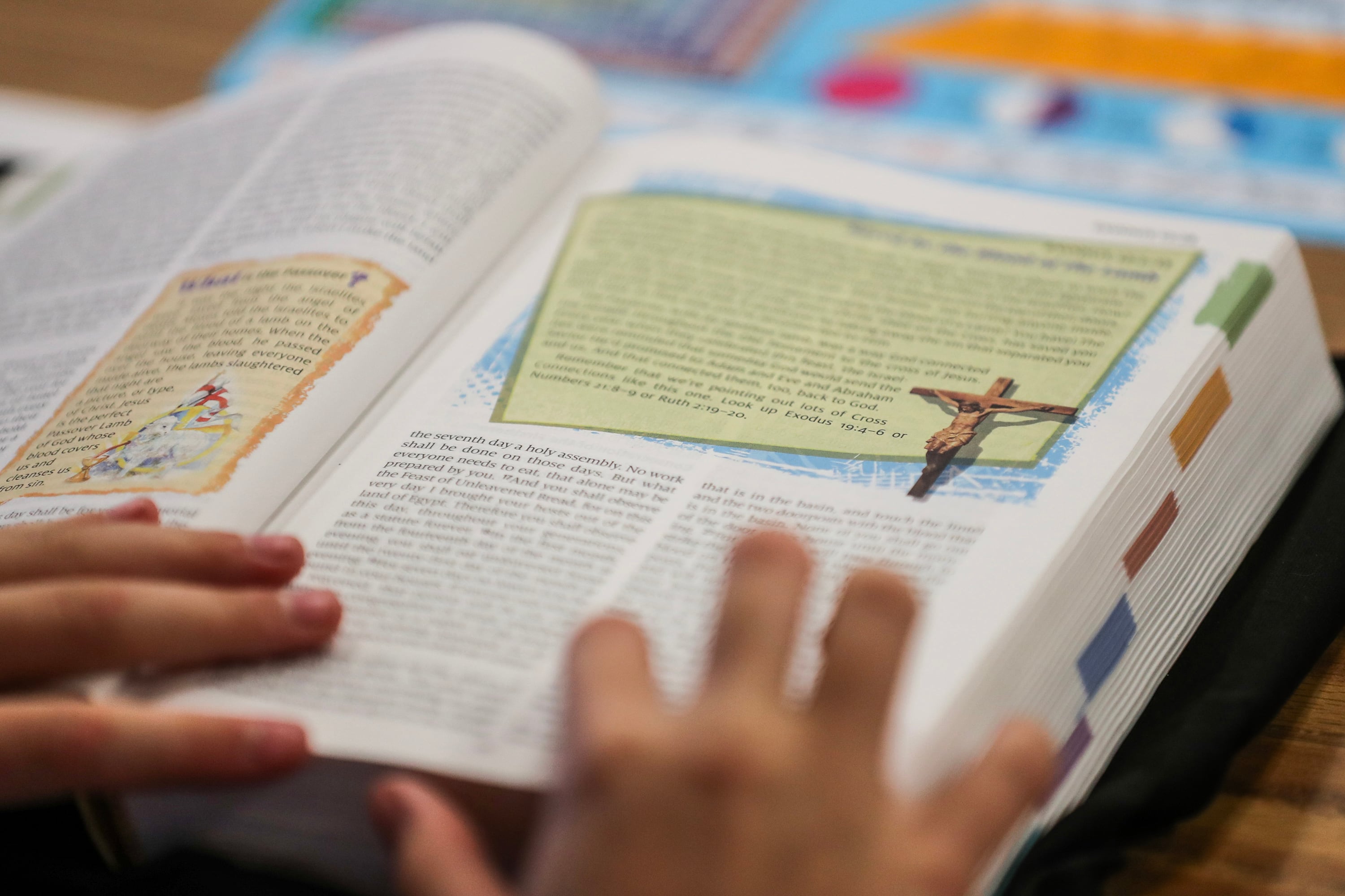 Hands rest on a book.