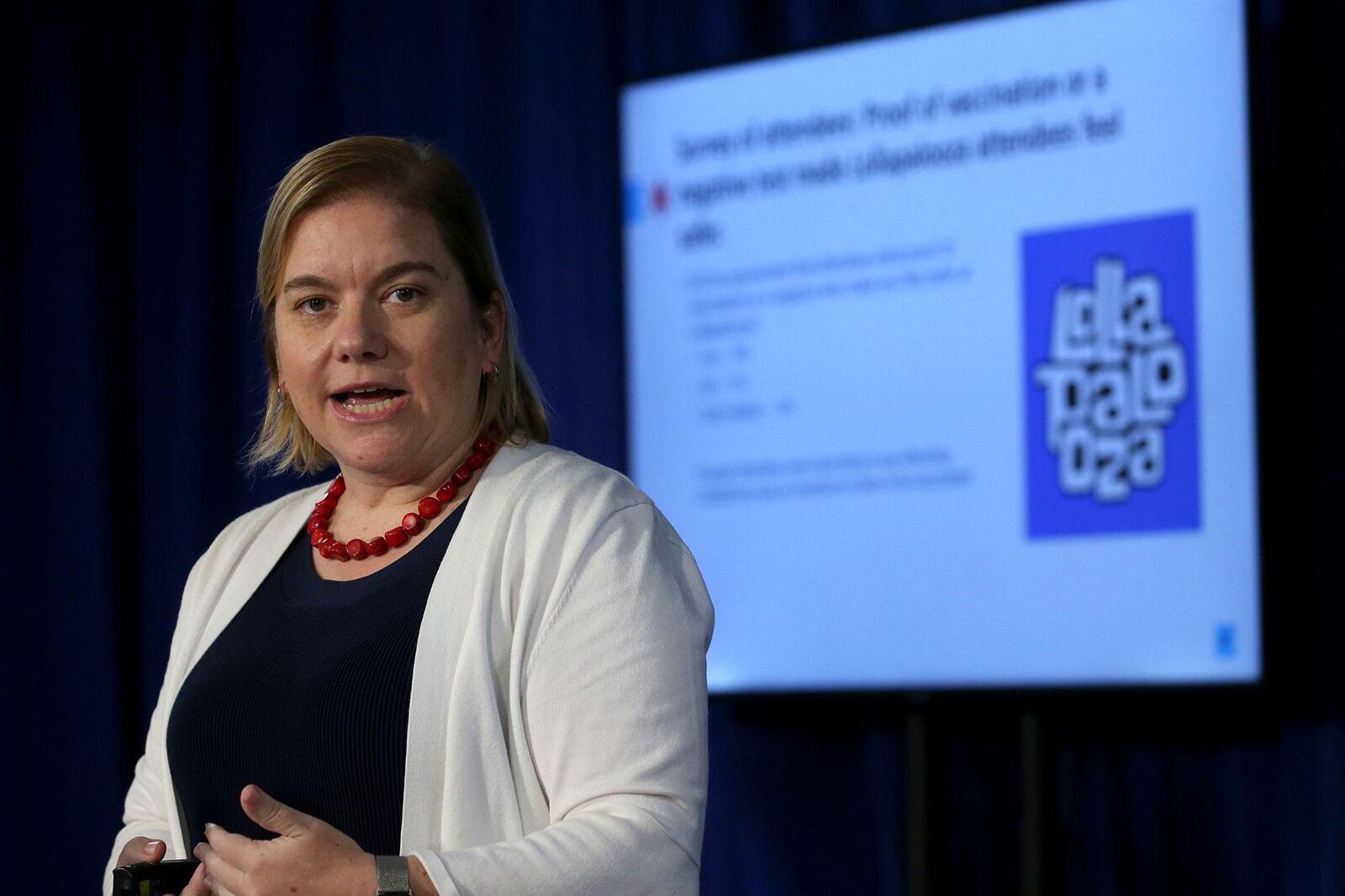 The city’s health commissioner Dr. Allison Arwady, wearing a white sweater and red beaded necklace, provides COVID-19 case data and vaccinations on Aug. 12, 2021.