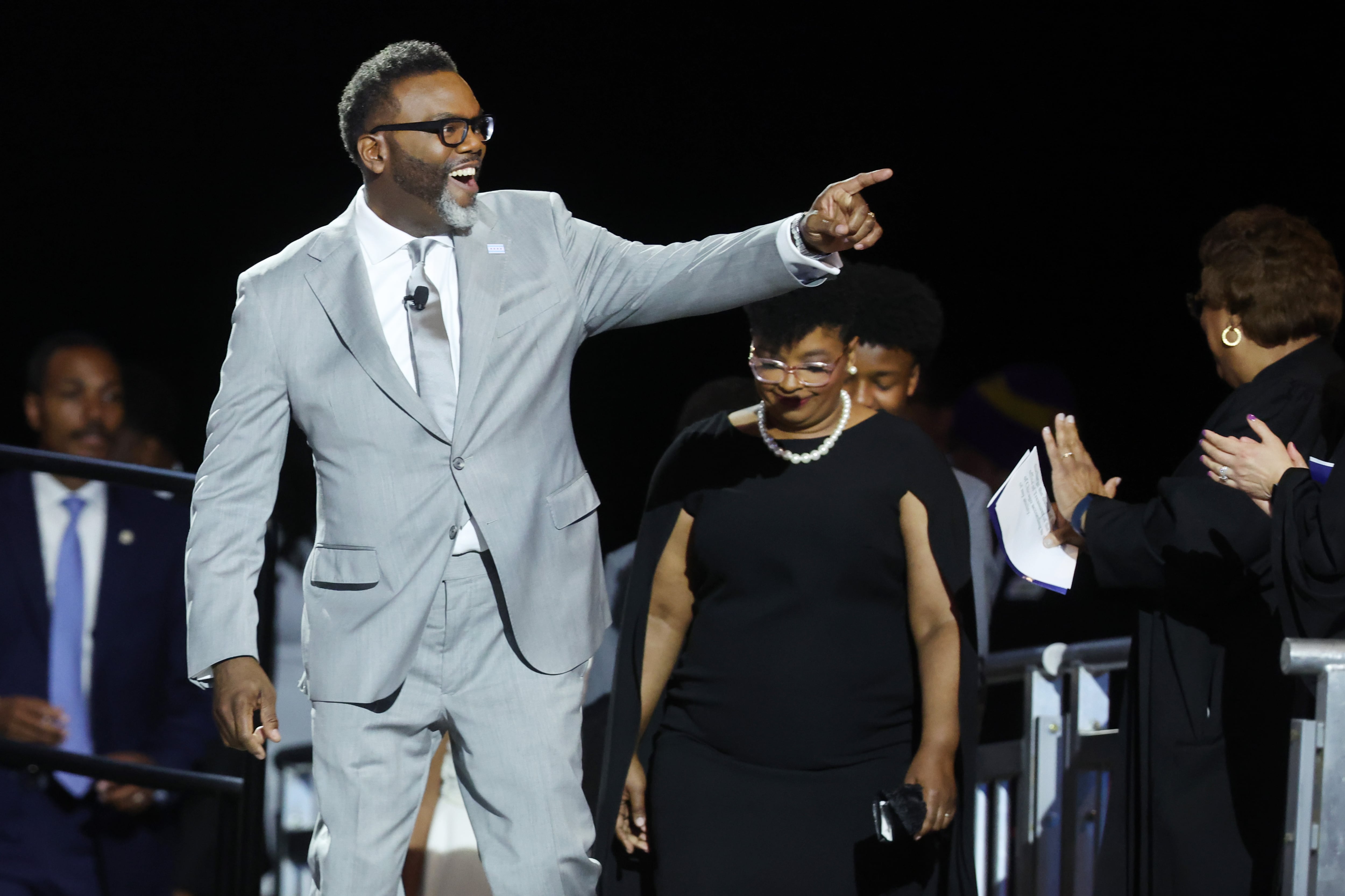 A man in gray suit points.