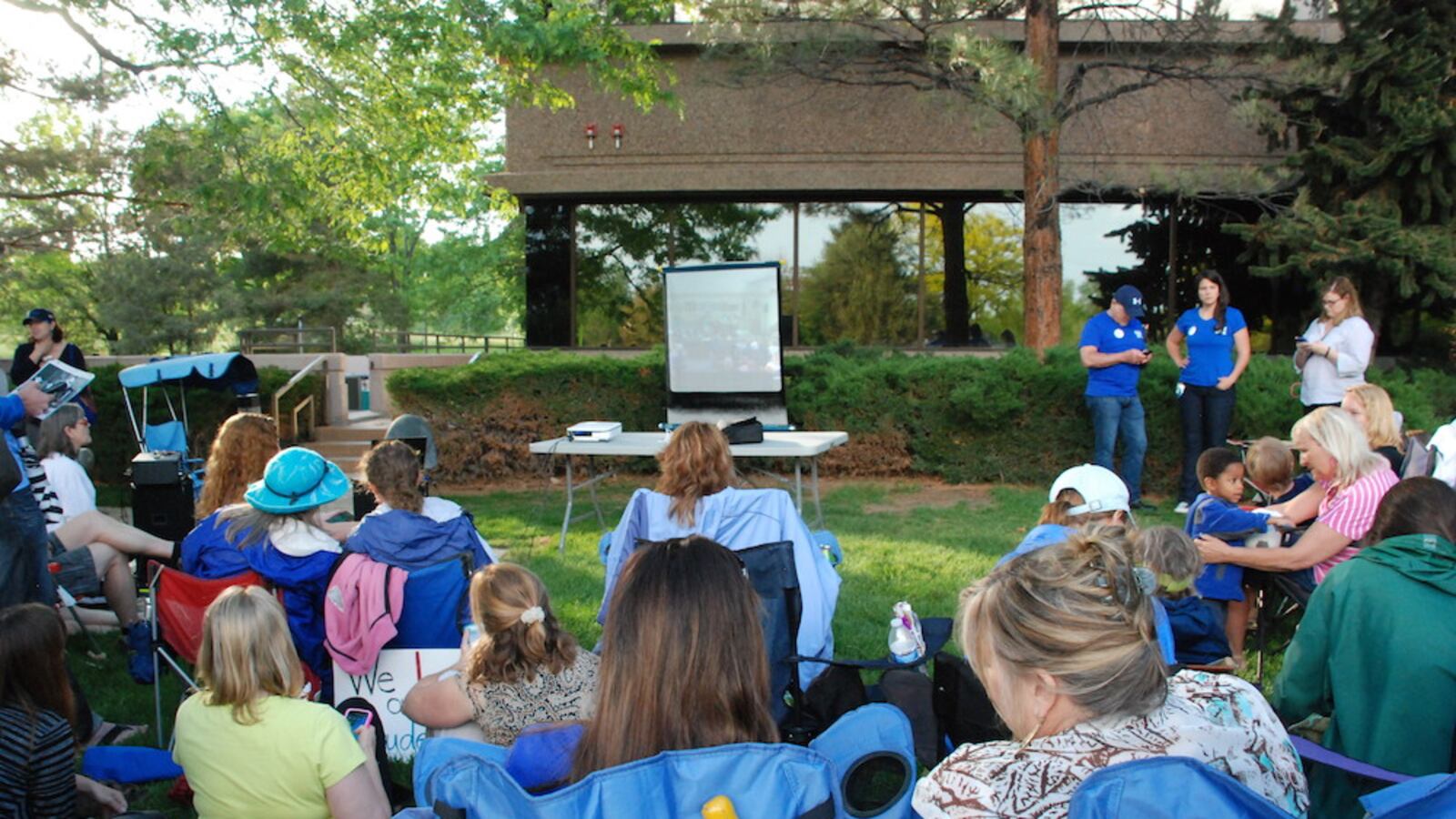 Jefferson County teachers and parents gather around a screen and loud speaker streaming the school board meeting outside the Jeffco Public Schools headquarters in Golden  Thursday.