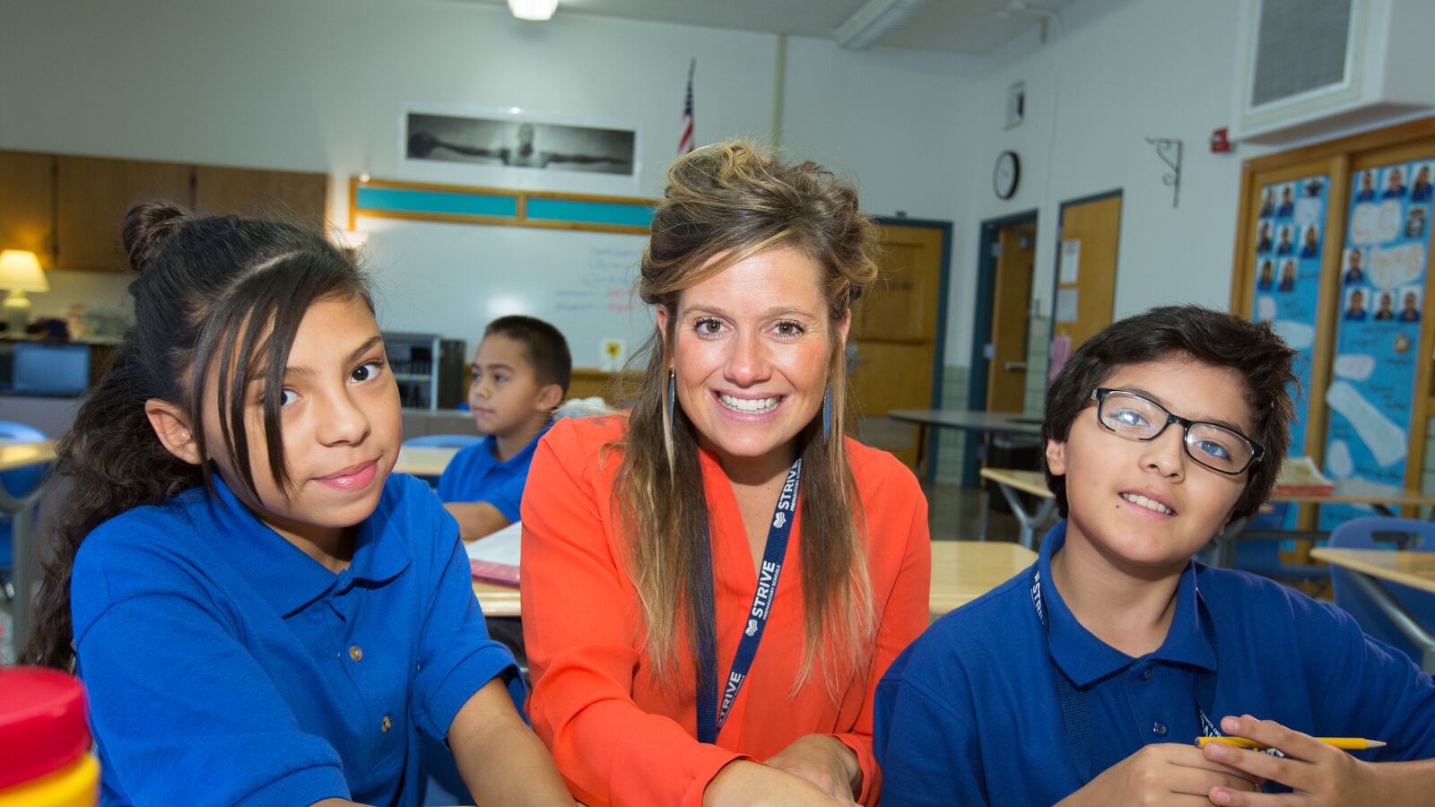 Kathleen Anderson, a Language Arts teacher at STRIVE Prep-Kepner, with two students.