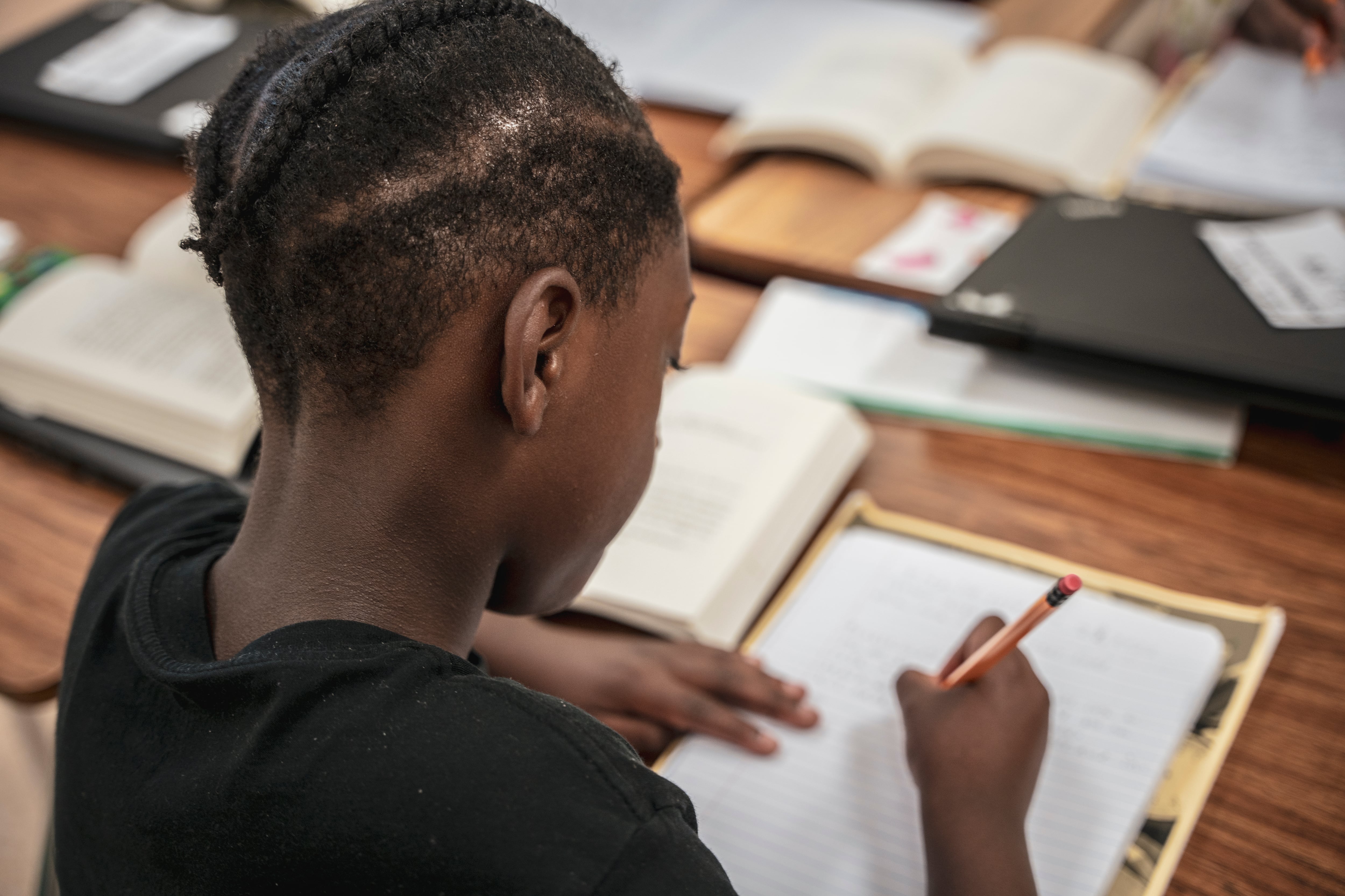 Looking over the shoulder of a young student working on a