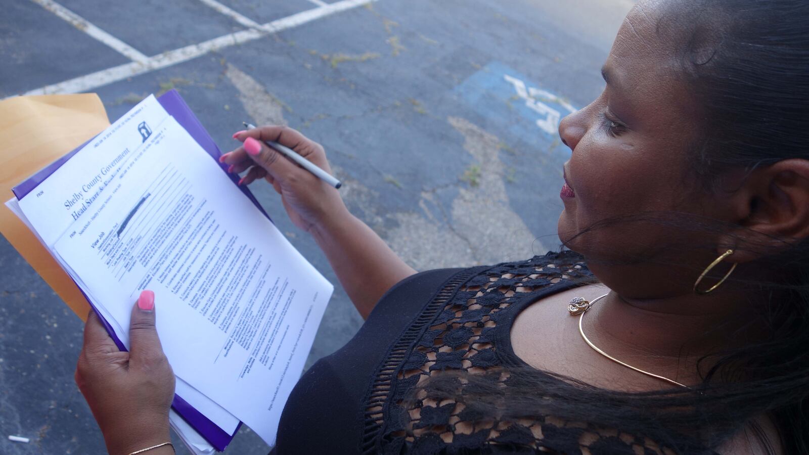 Netra Weathery, the union representative for the protesting workers, showed Shelby County Schools' plan to outsource Head Start services to 2,200 children.