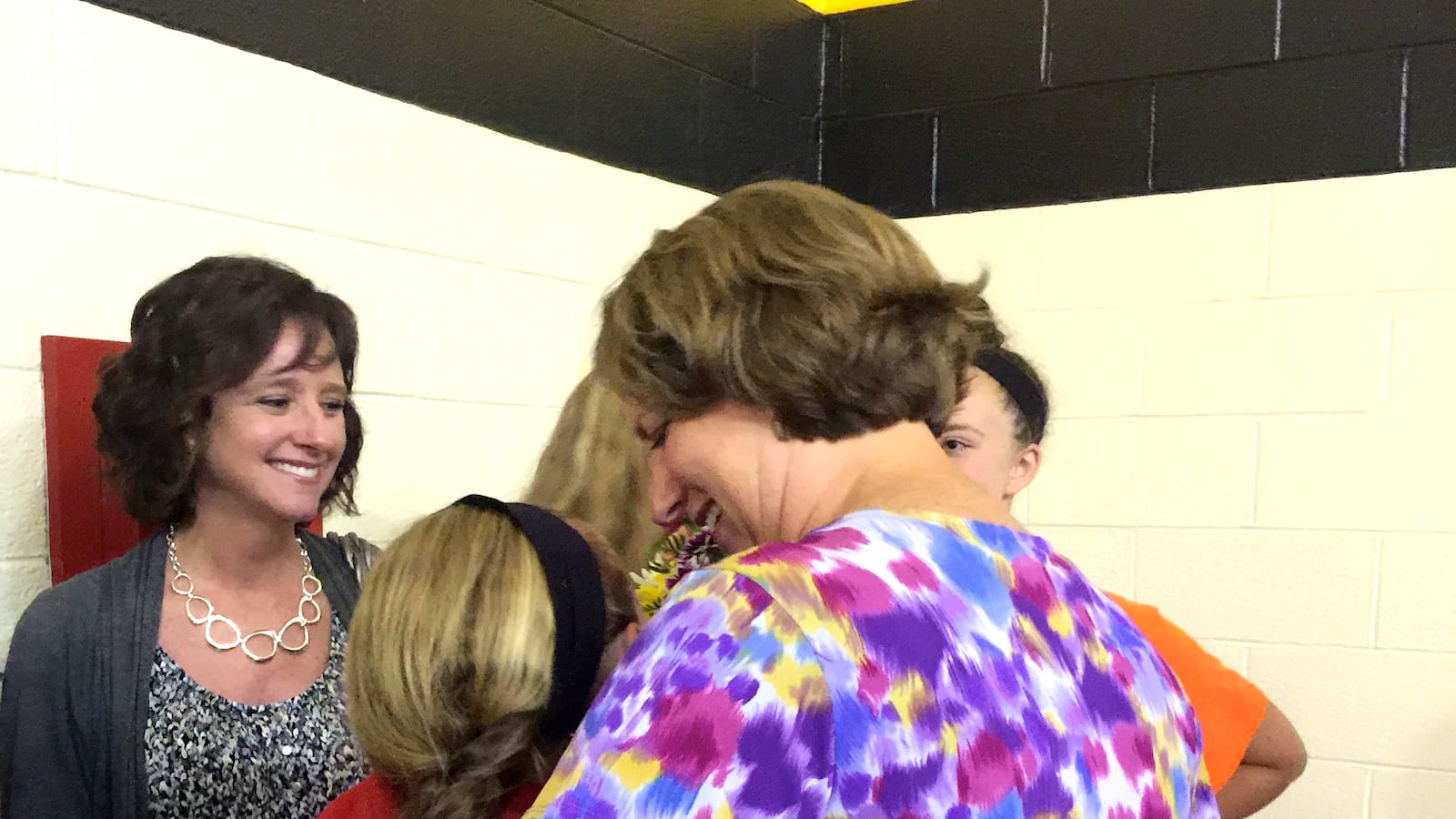 IPS teacher of the year Amy Wackerly hugs her daughter after the announcement at School 2 in June.