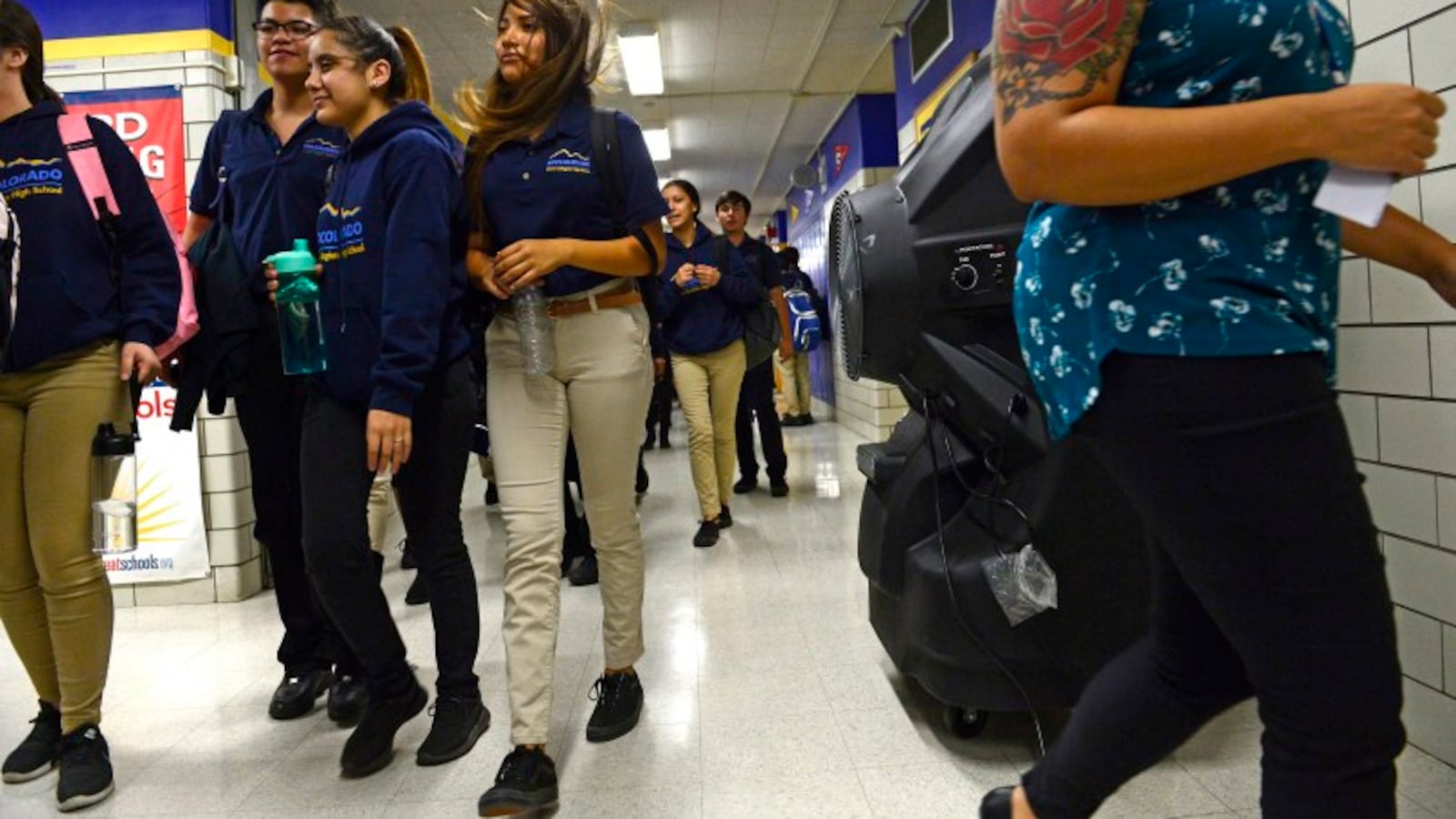Students walk by large portable cooling systems set up in the hallways of KIPP Denver Collegiate High School in 2018.