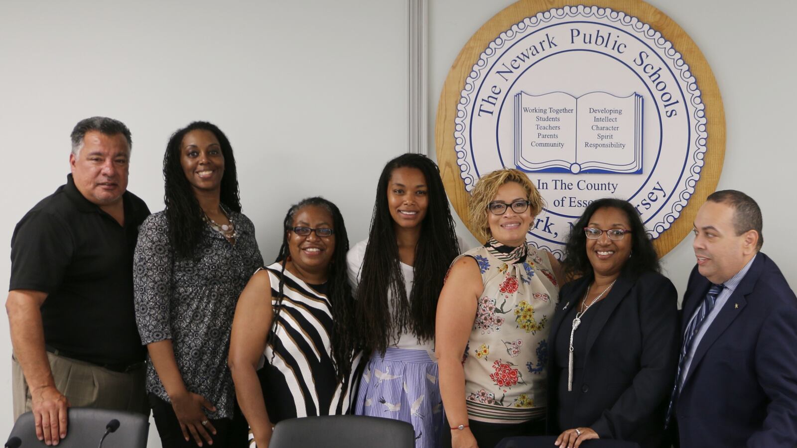Newark school board members Tave Padilla and Leah Owens, standing side by side on the left, are running for reelection next month on opposing teams.